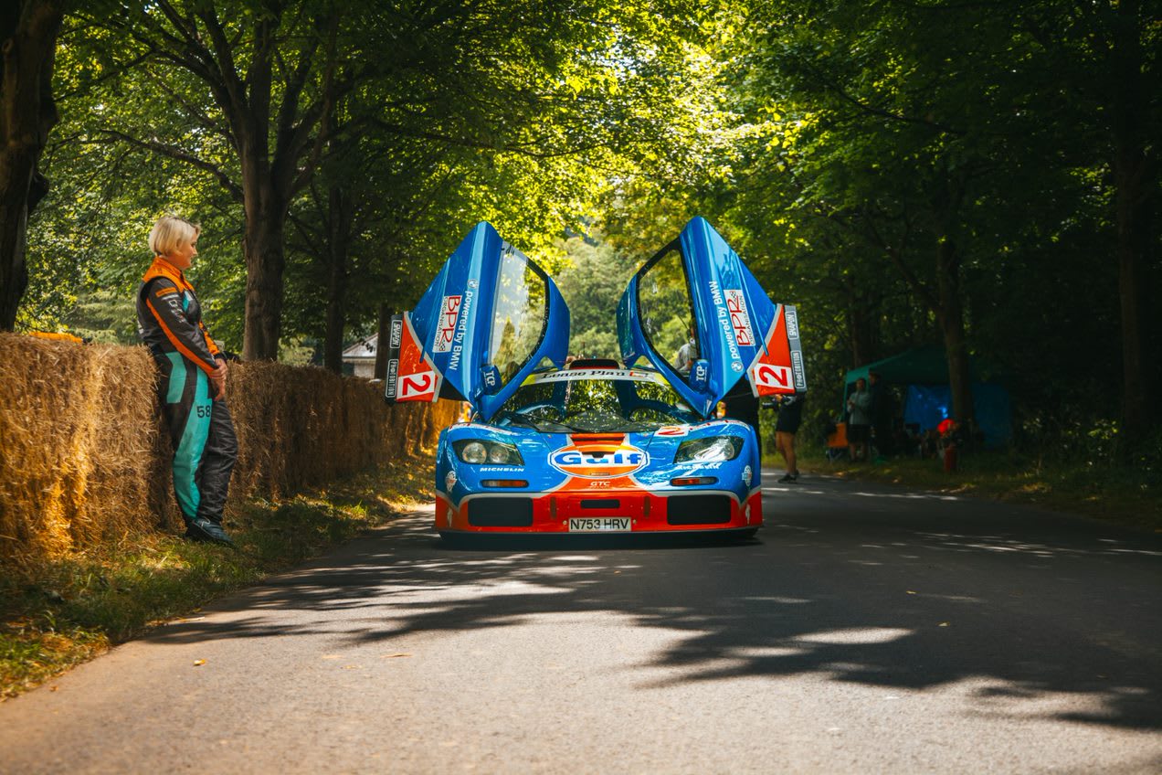 photo of a blue and orange Mclaren F1GT 12R with both its gulwing doors open.