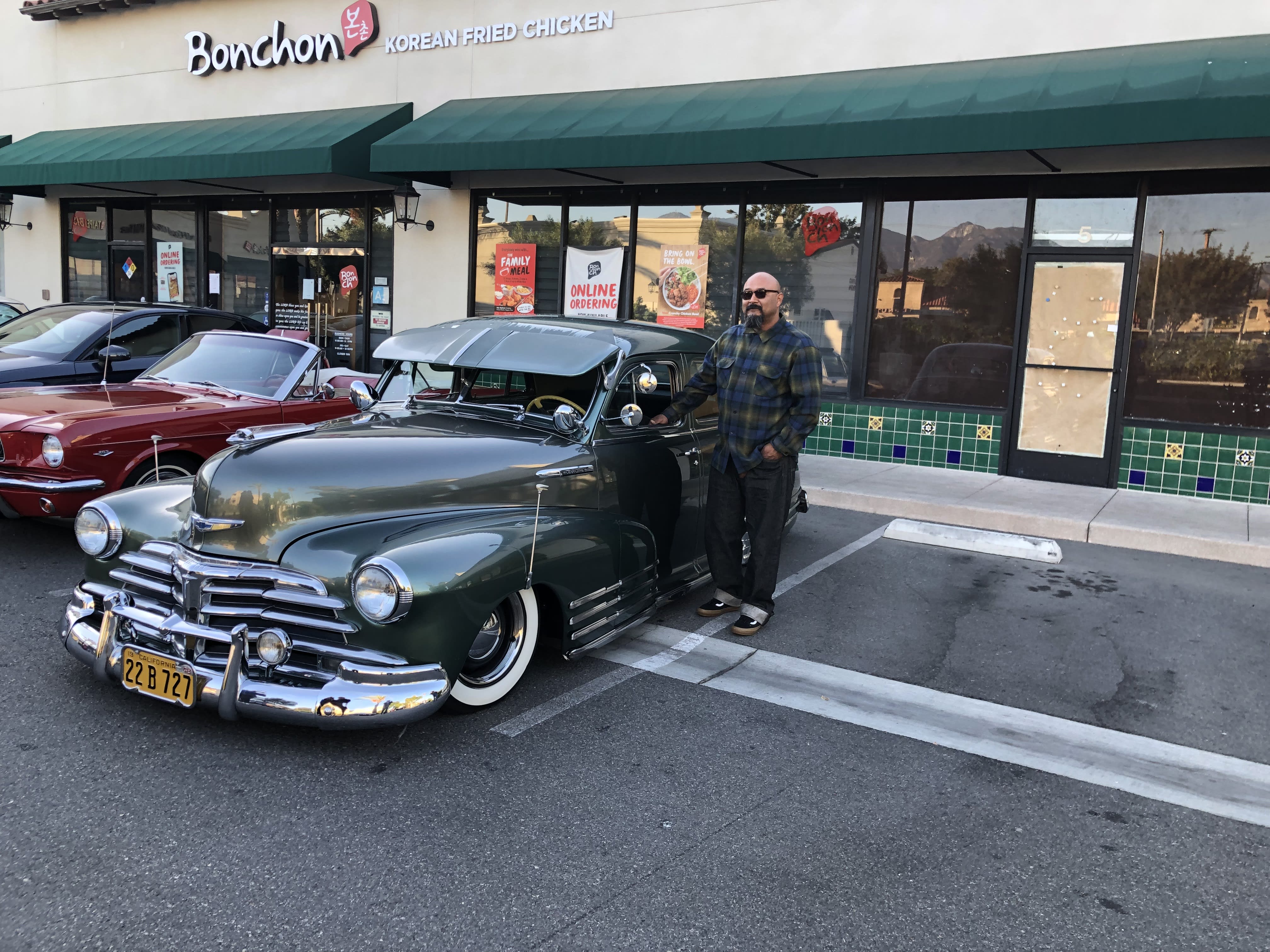 image of a dark green 1948 Chevy Fleetline at the Cars And Coffee San Gabriel event.