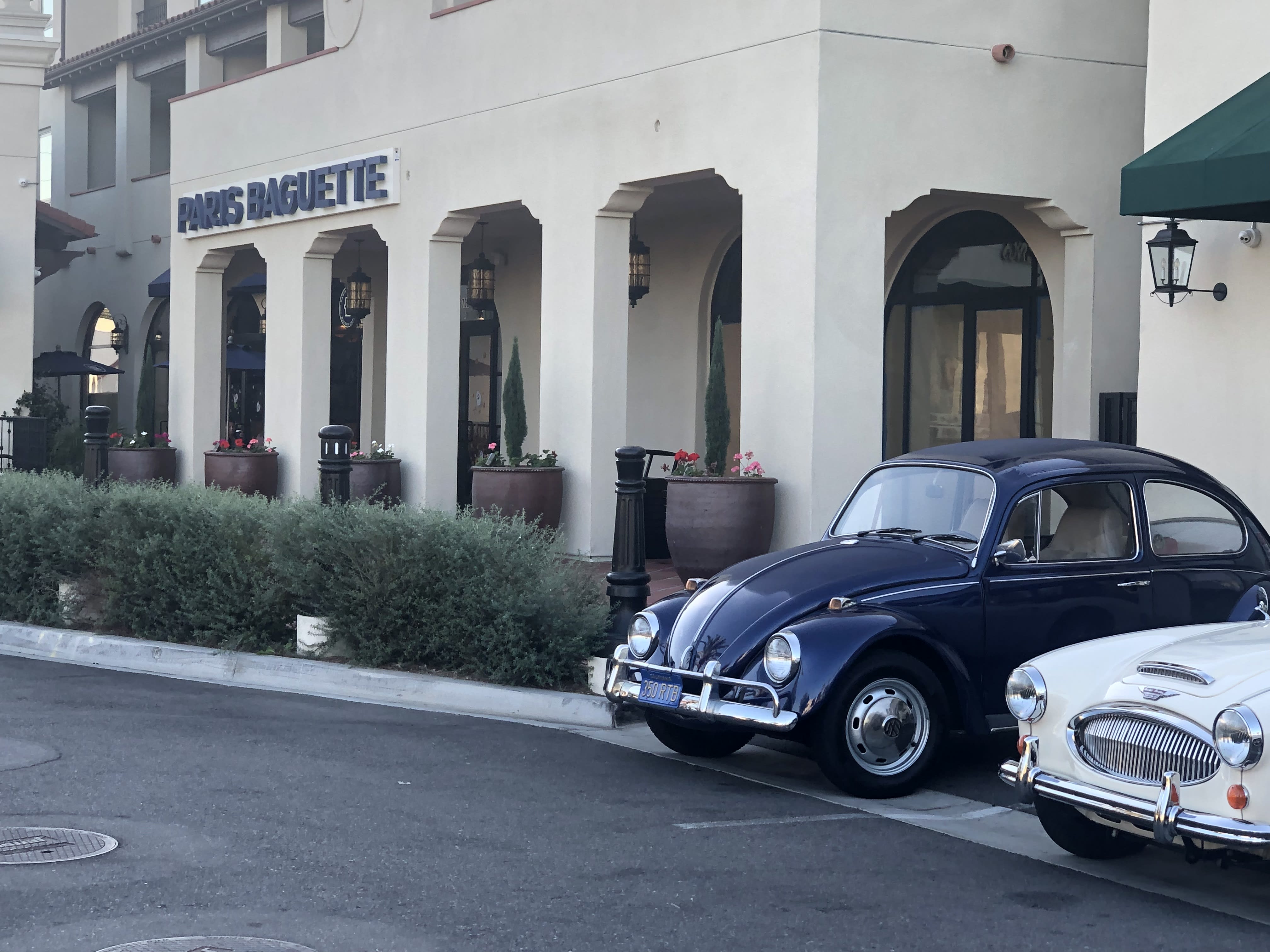 image of a dark colored 1968 VW Beetle on display at the Cars And Coffee San Gabriel event on October 29th 2022