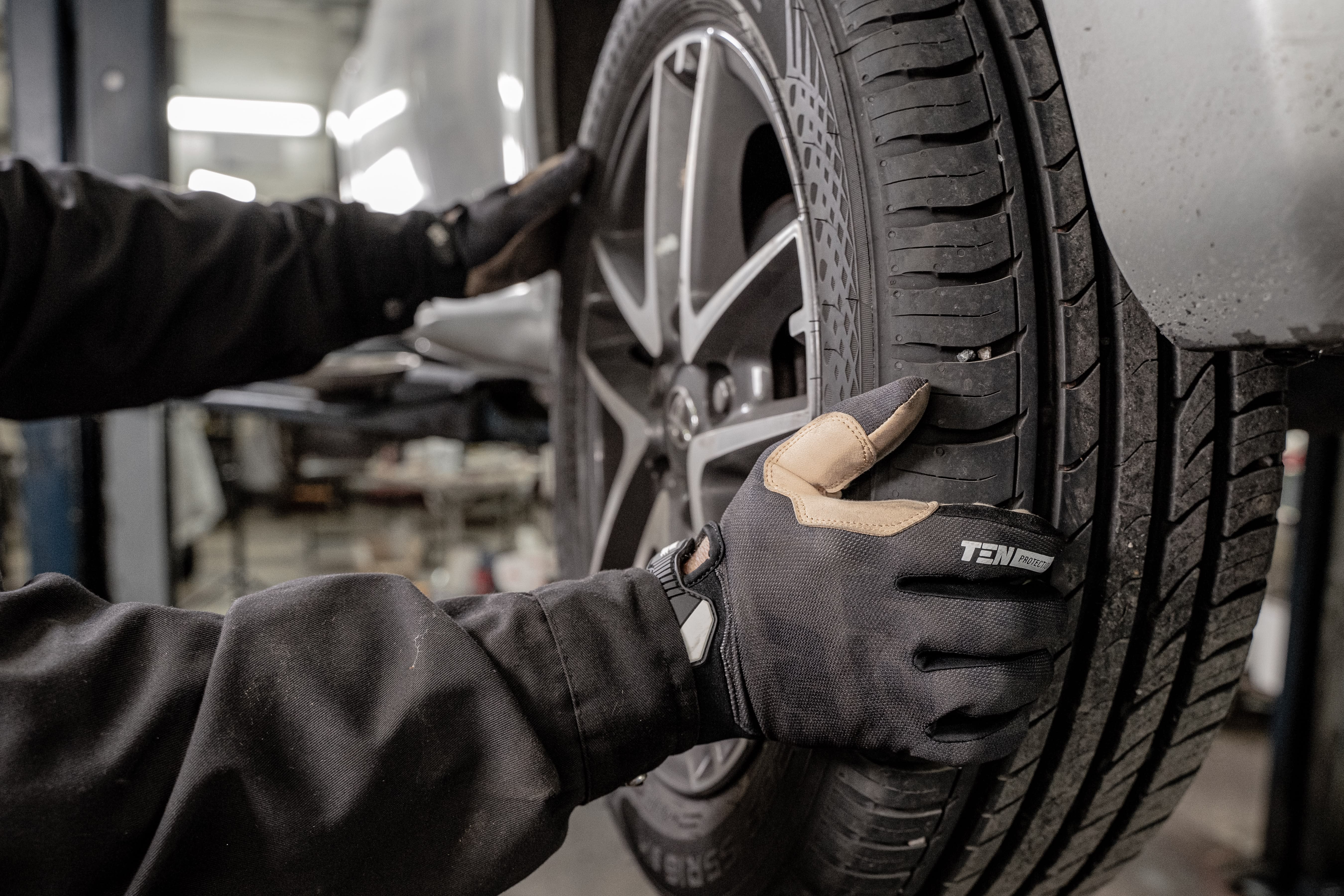 mechanic checking on the tires at a tire shop