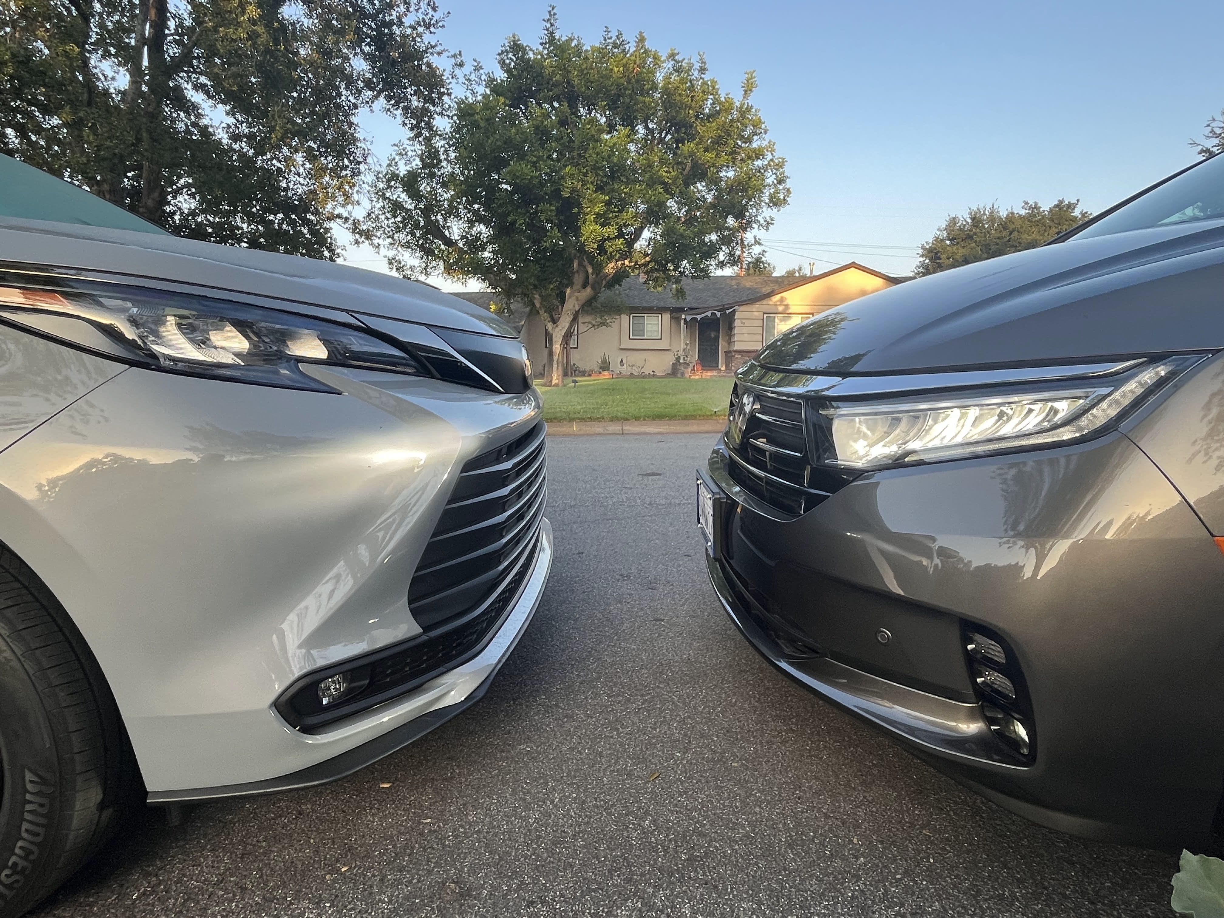 image of the Toyota Sienna and the Honda Odyssey parked nose-to-nose