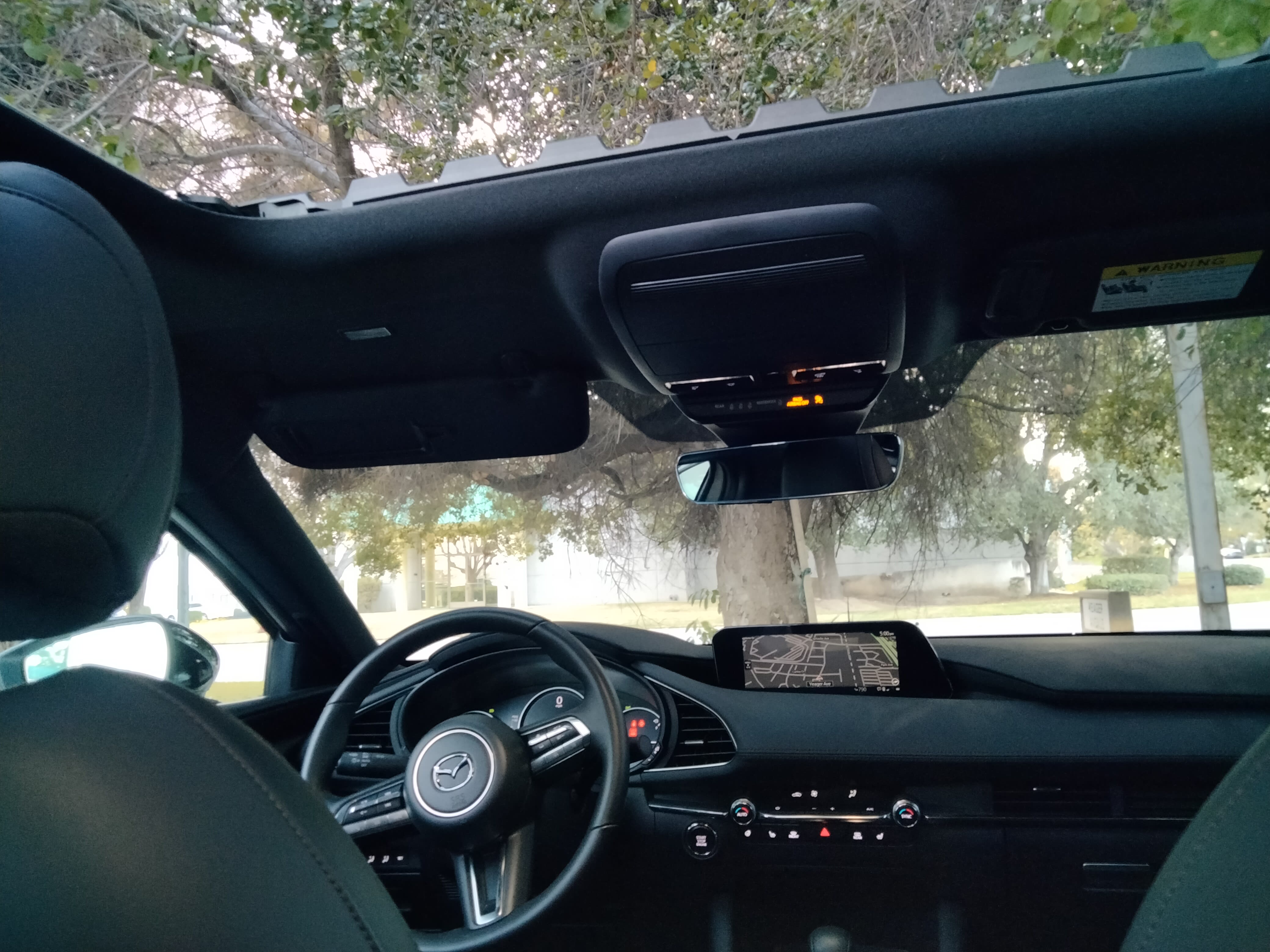 image of the interior of the 2023 Mazda3 hatchback, including the large sunroof