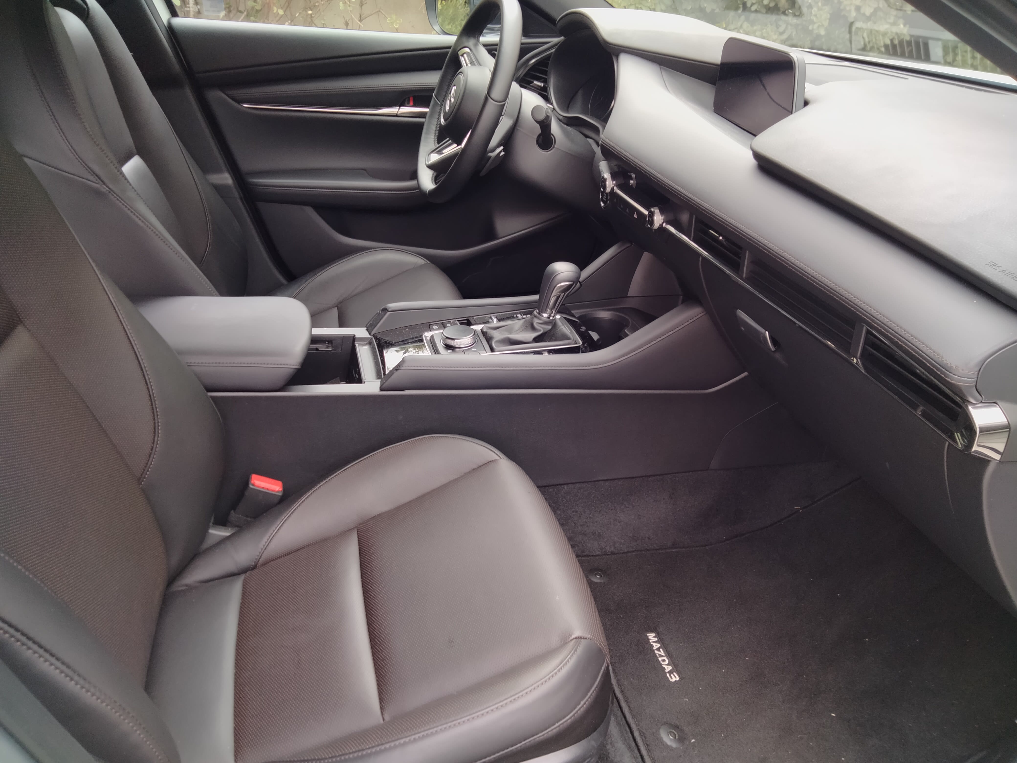 view of the interior of the 2023 Mazda3 hatchback as seen from the side of the vehicle