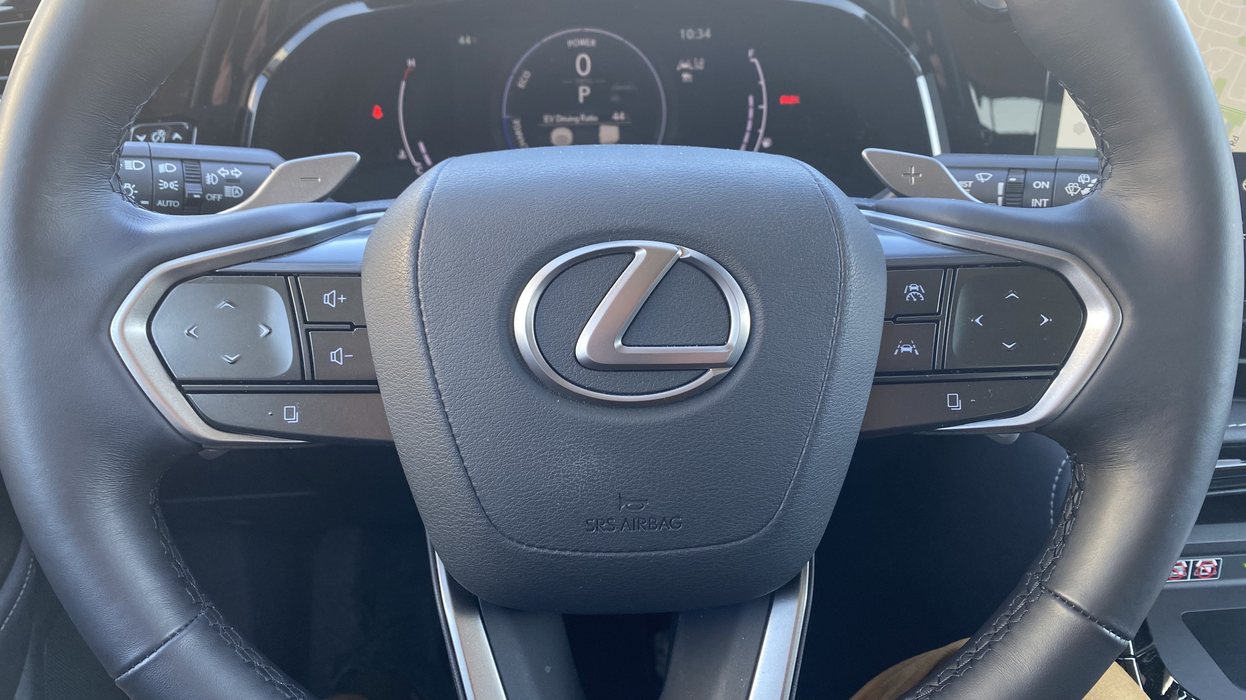 closeup of the steering wheel and its buttons in the 2023 Lexus NX350h Luxury