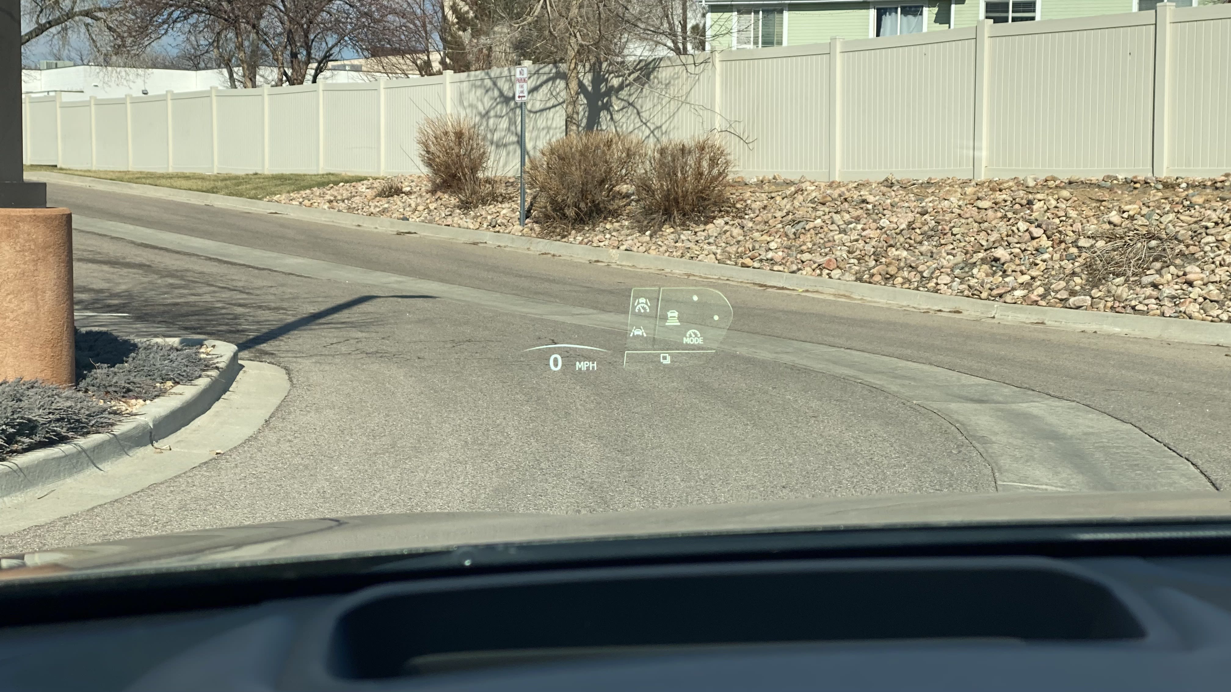 an image of the head-up display helping the driver remember which button does what.