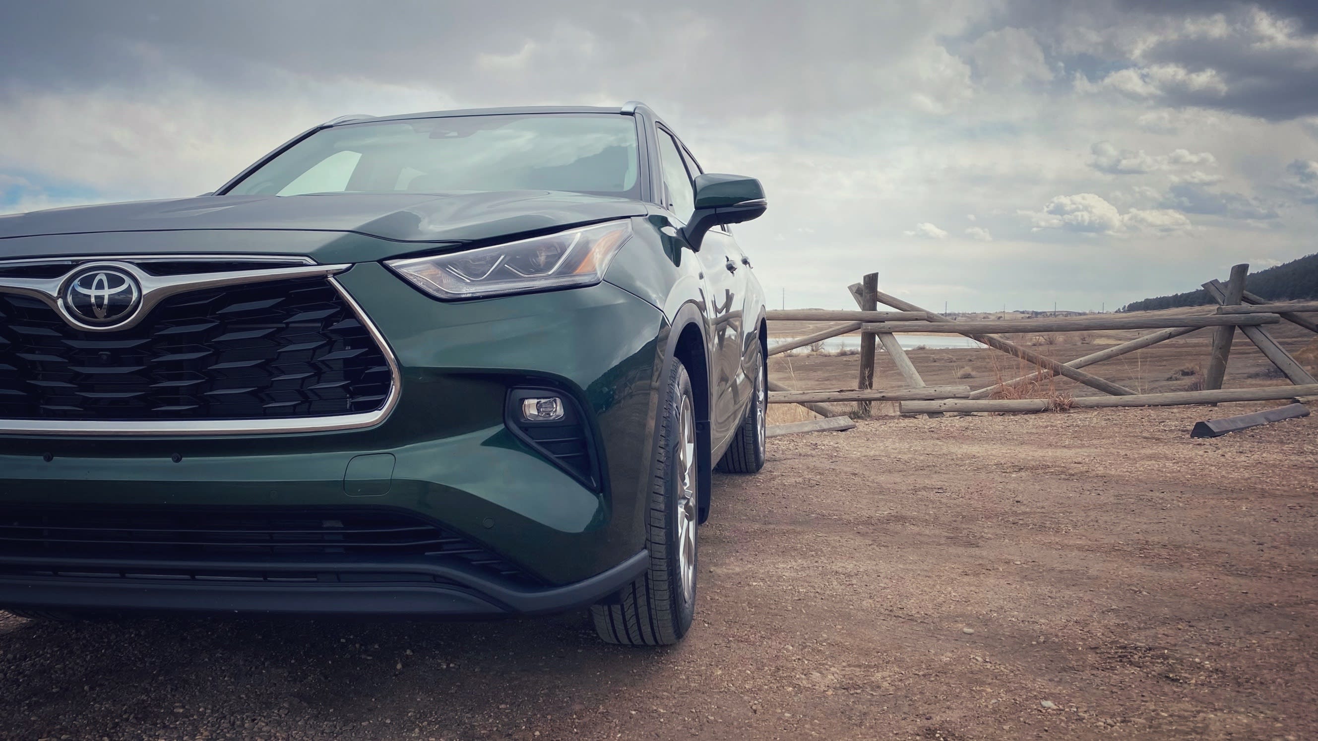closeup image of the front of the 2023 Toyota Highlander Limited sporting a very green exterior.