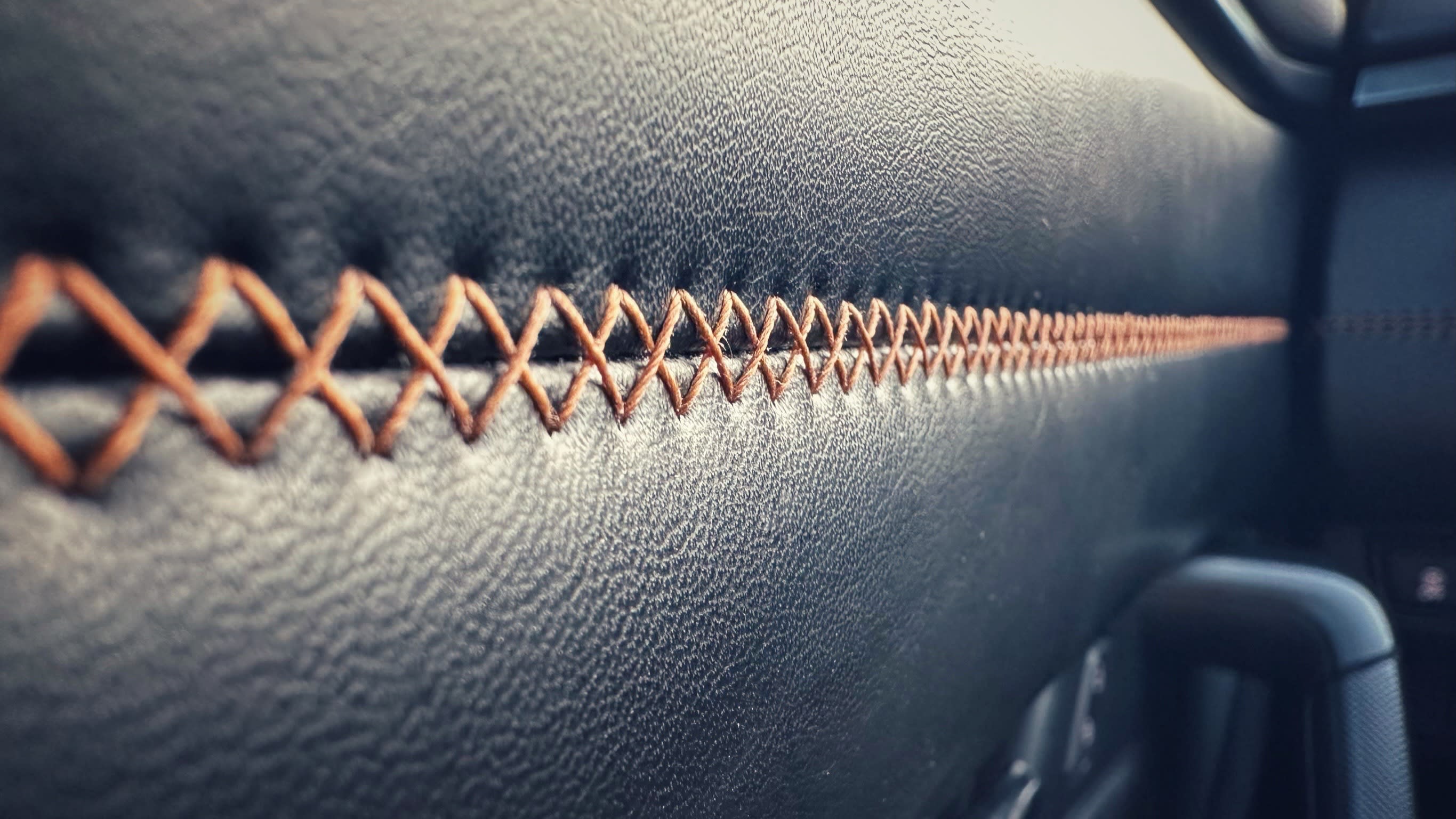 closeup image of the brown stitching on black leather in a Mazda CX-50