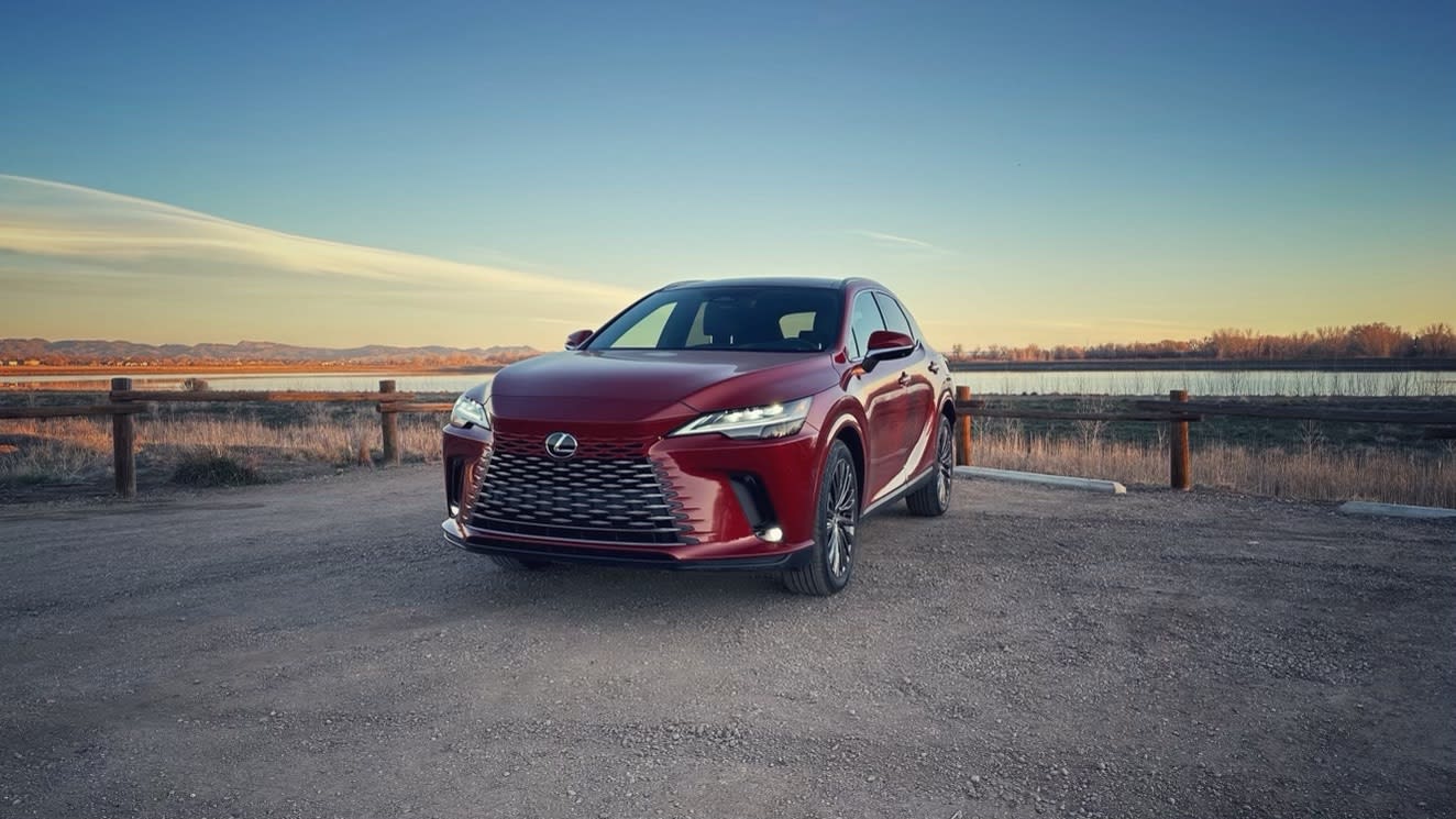 exterior image of the 2023 Lexus RX350h as seen from the front side, with a sunrise in the background.