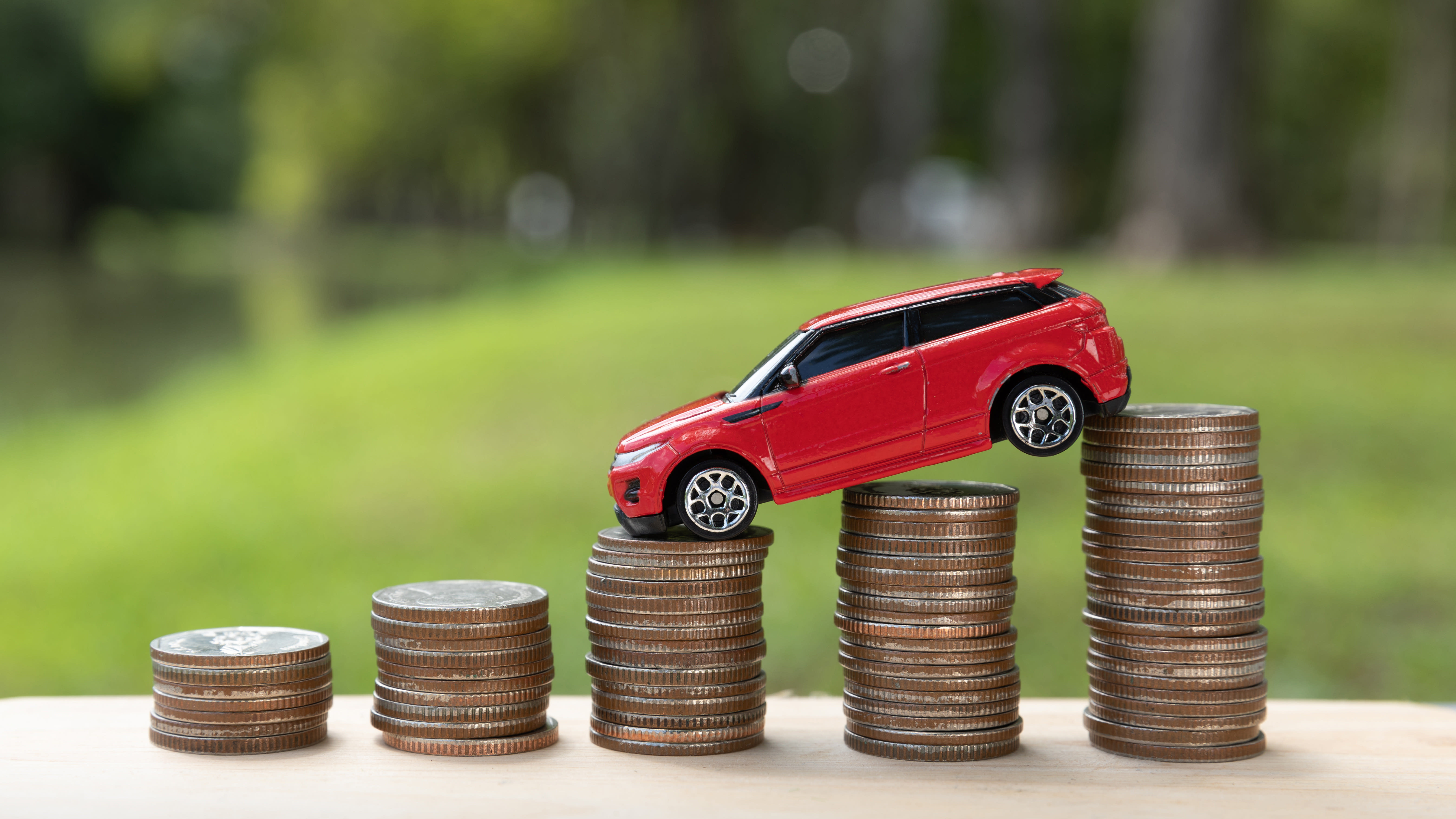 toy car balancing on piles of coins