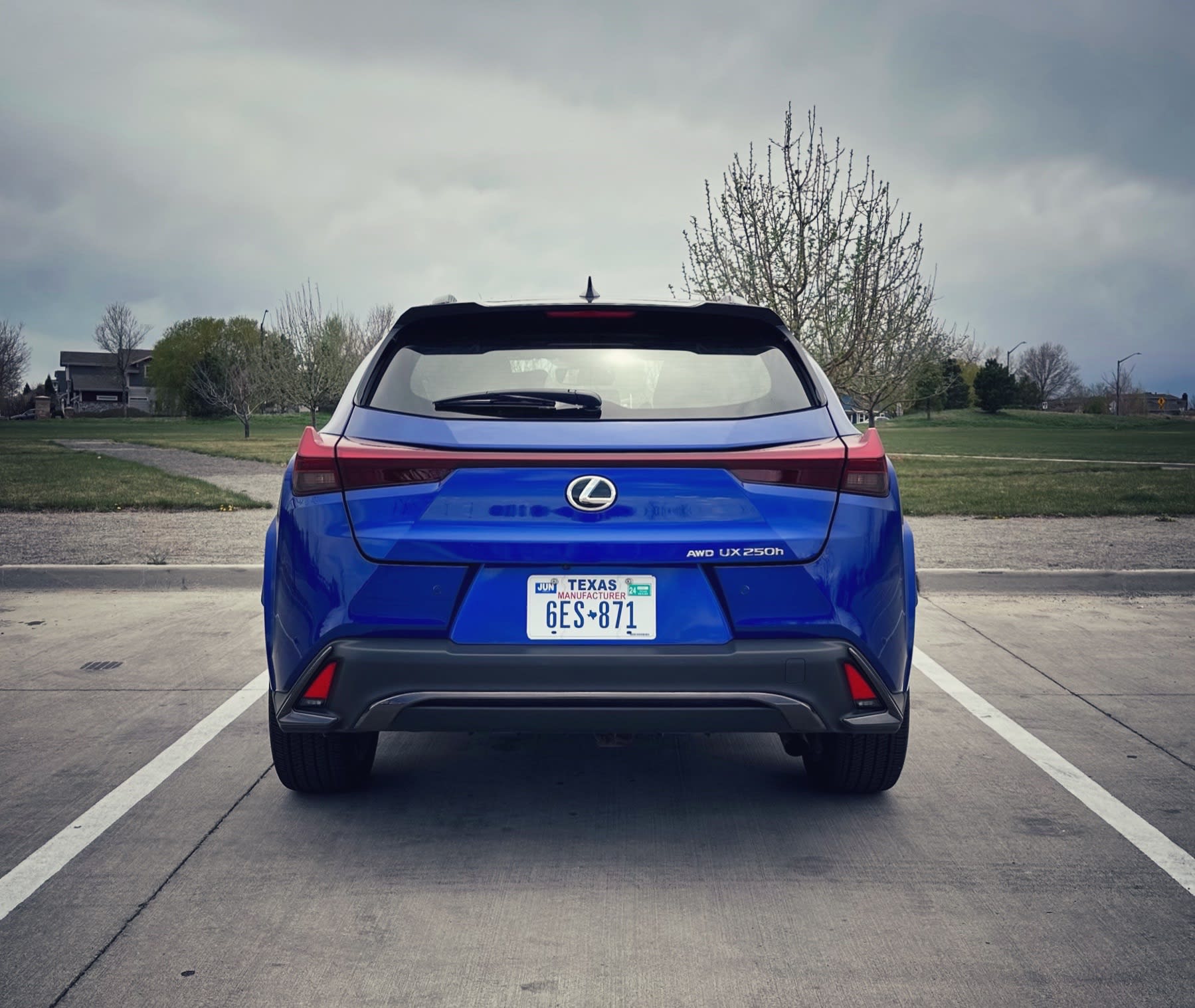 a blue 2023 Lexus UX as seen from behind