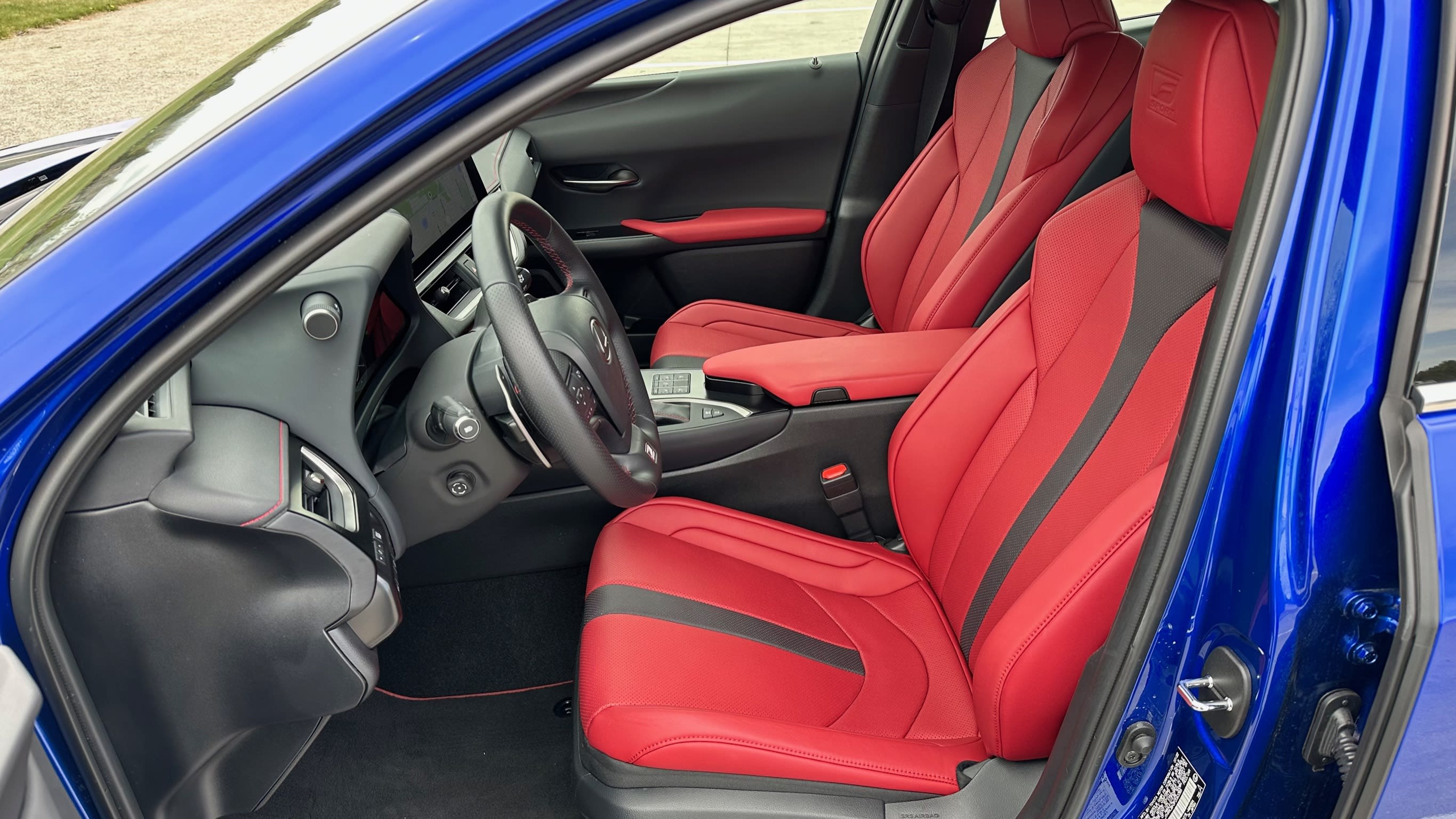 front interior of a blue Lexus UX with red interior leather