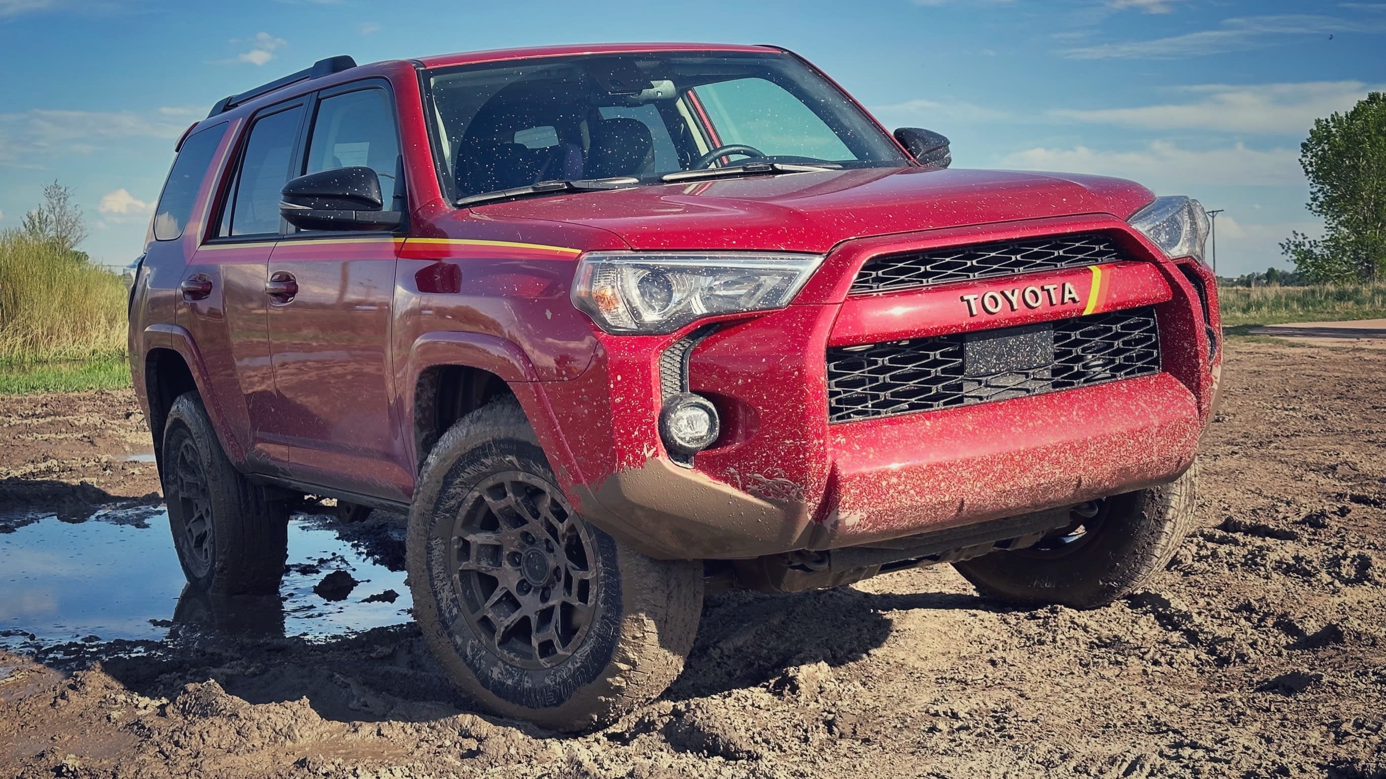 A 2023 Toyota 4Runner driving through mud