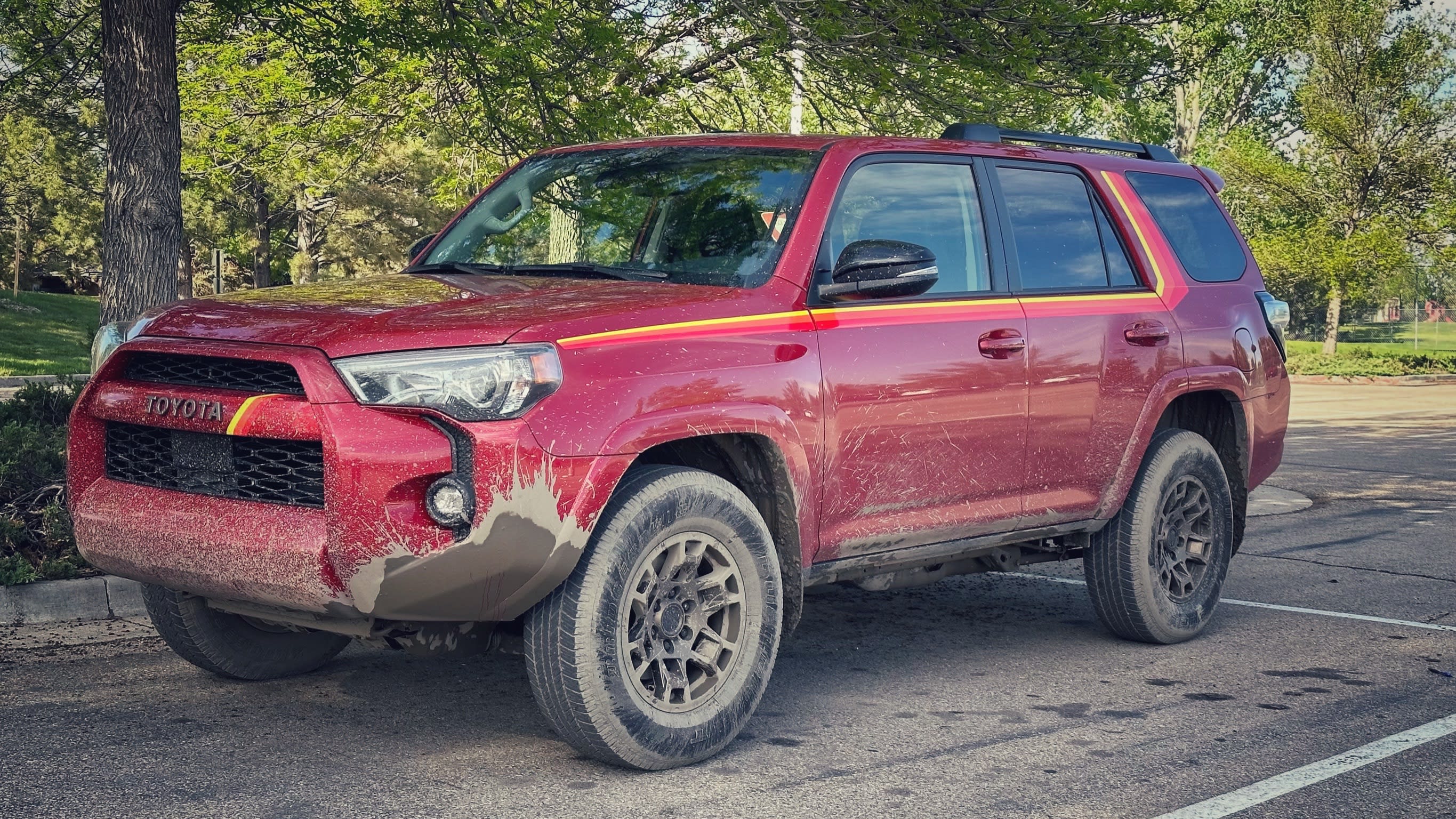 a 4runner dripping mud in a school parking lot