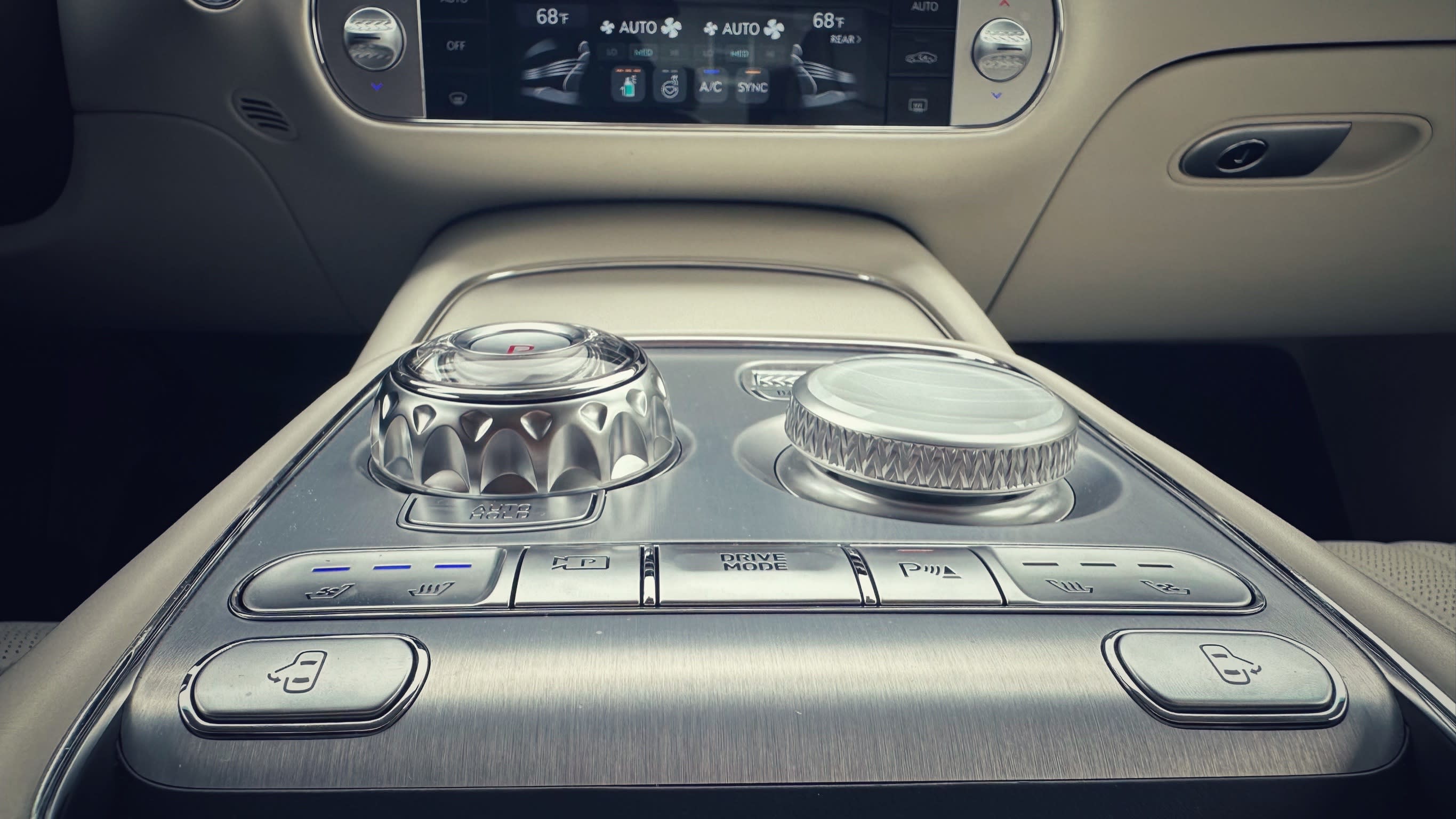 interior image in the 2023 Genesis G90 showing the diamond-like knobs in the center console.