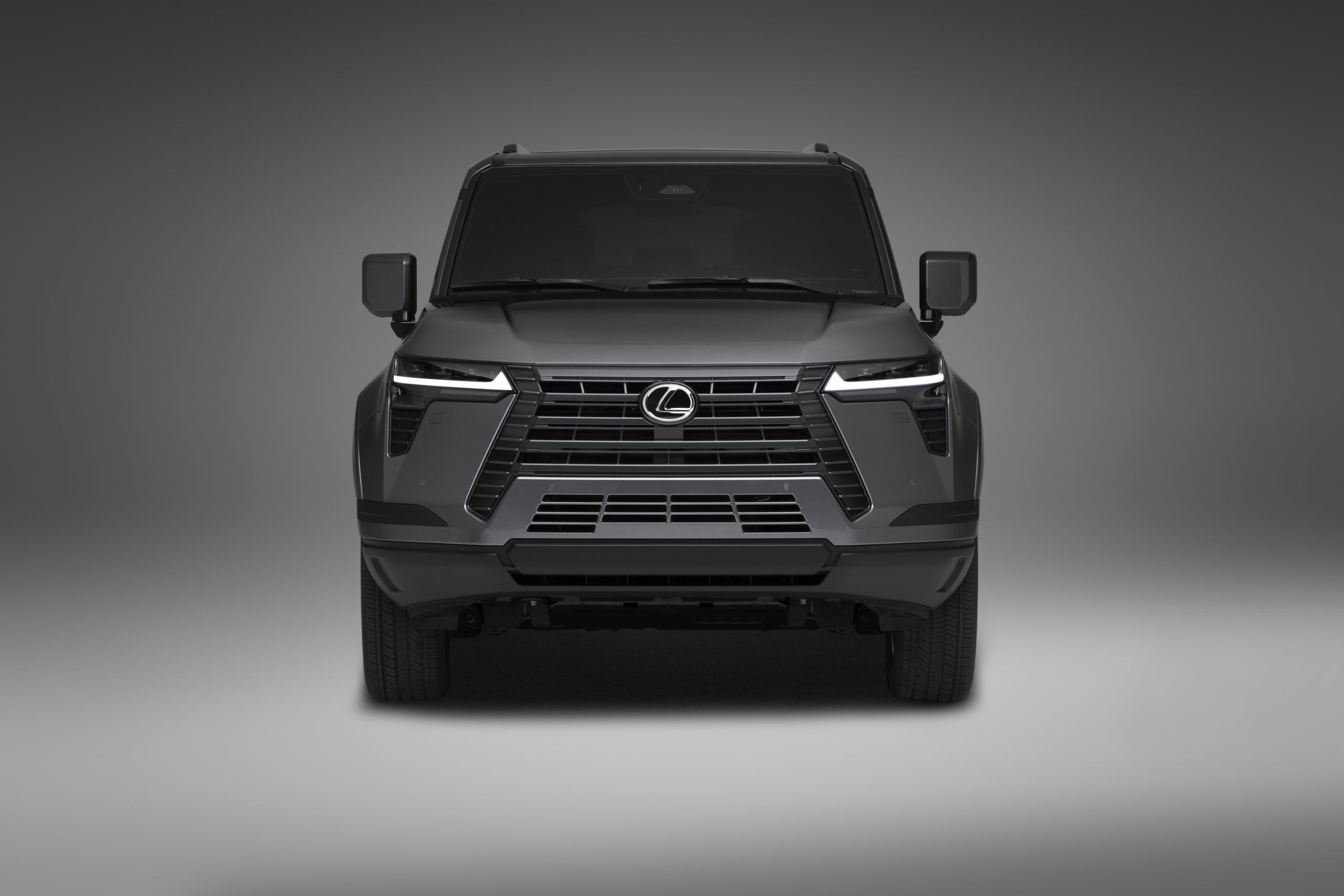 front of a dark gray 2024 Lexus GX