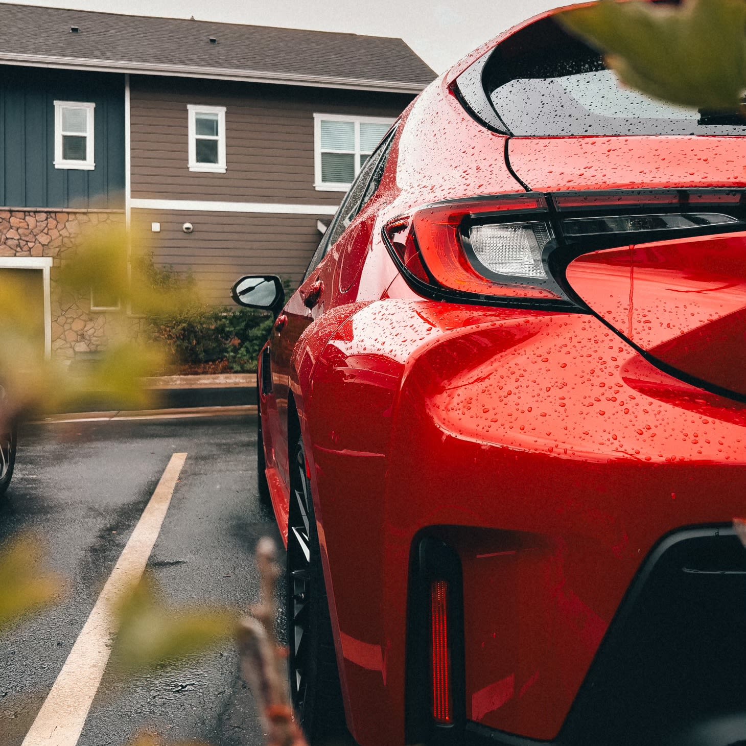 image of the 2023 Toyota GR Corolla, red. Parked by house.