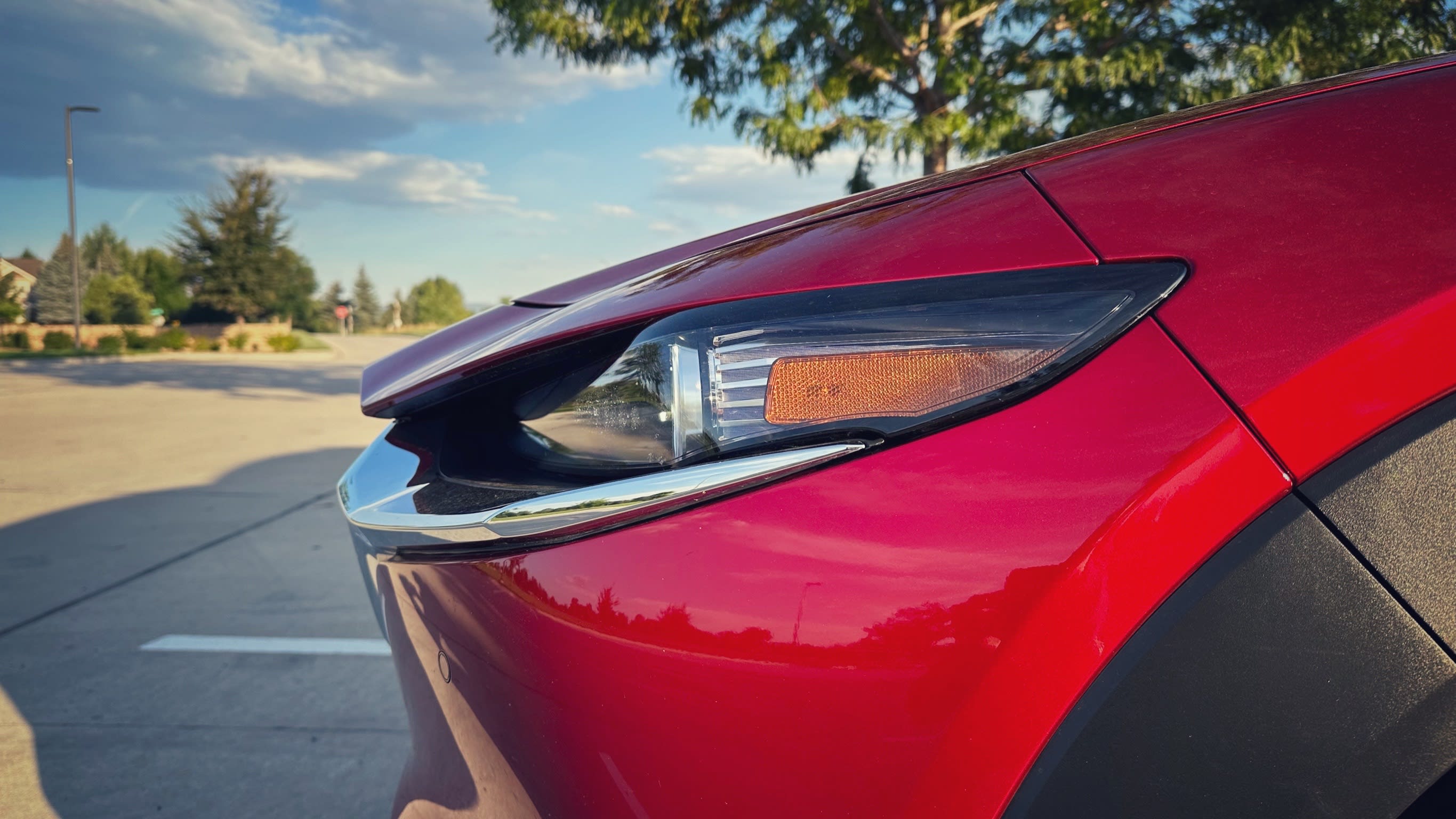 a closeup of the headlights of a red 2023 Mazda CX-30