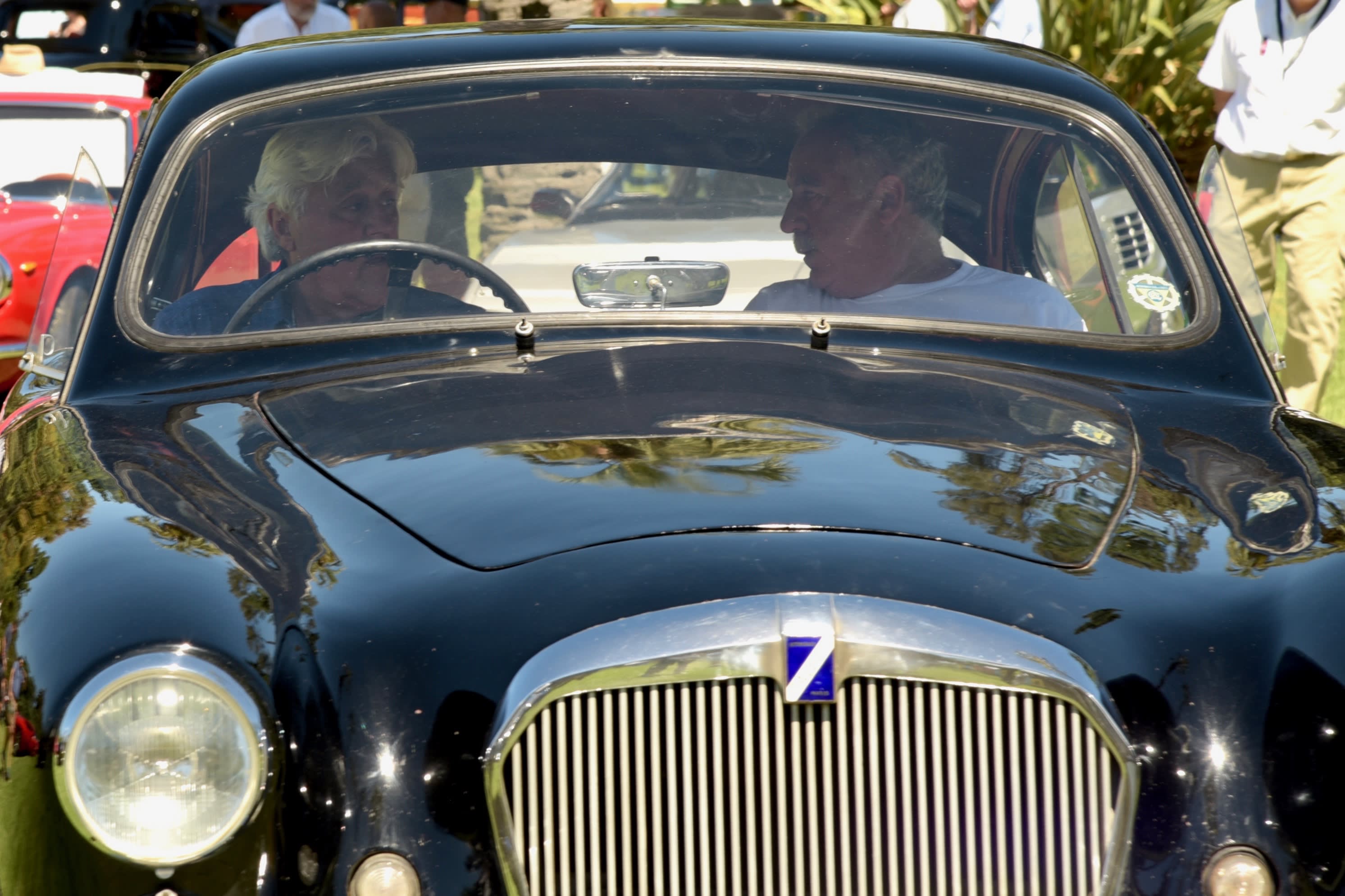 Jay Leno and unknown other dude in classic car