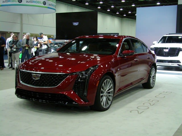a red Cadillac CT5 on display at the 2023 NAIAS