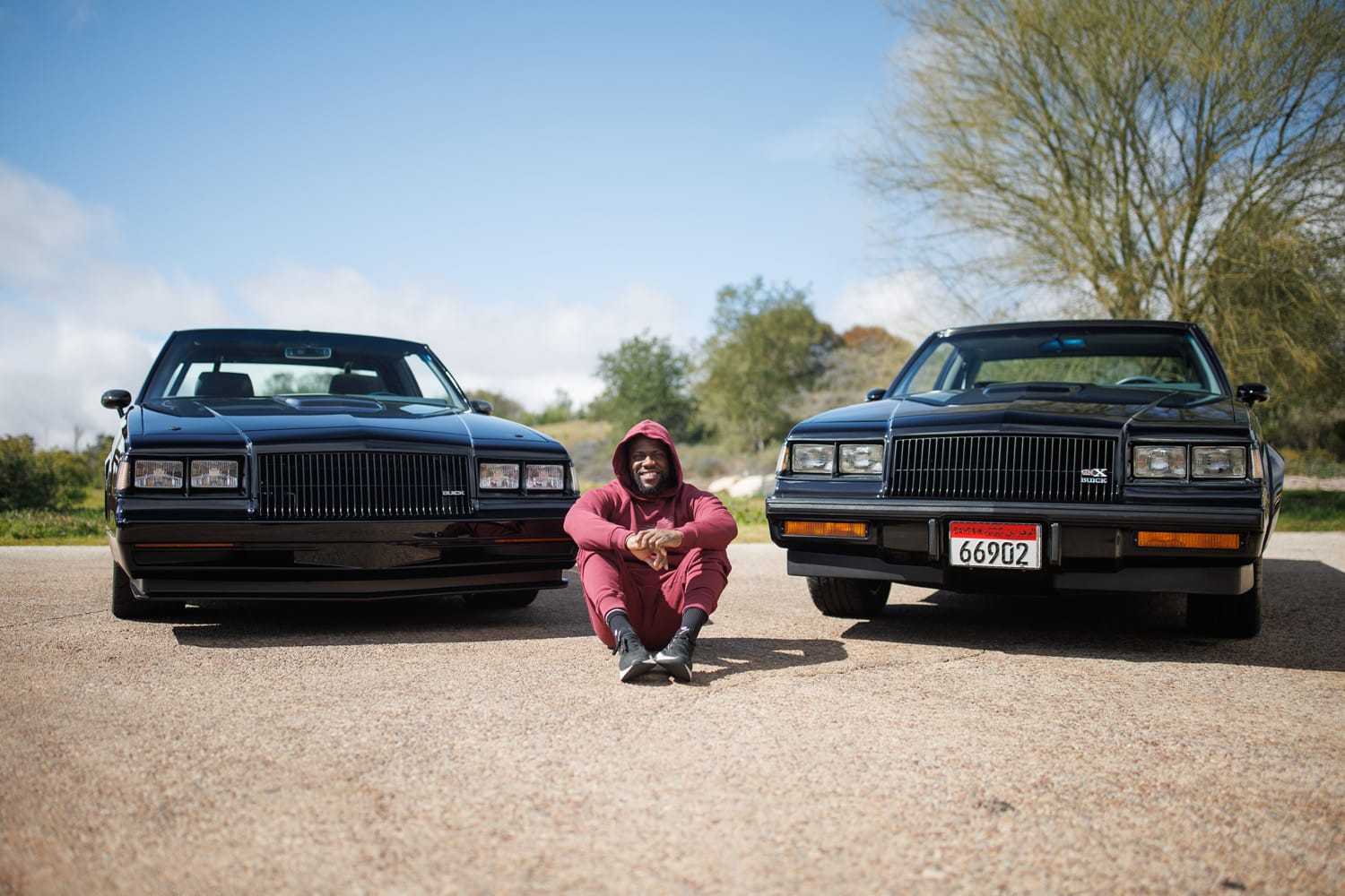 Kevin Hart with two of his cars