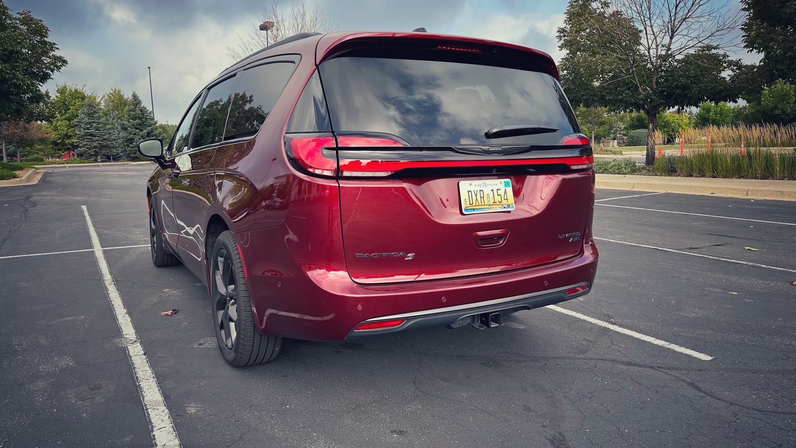 the rear and side of a red 2023 Chrysler Pacifica