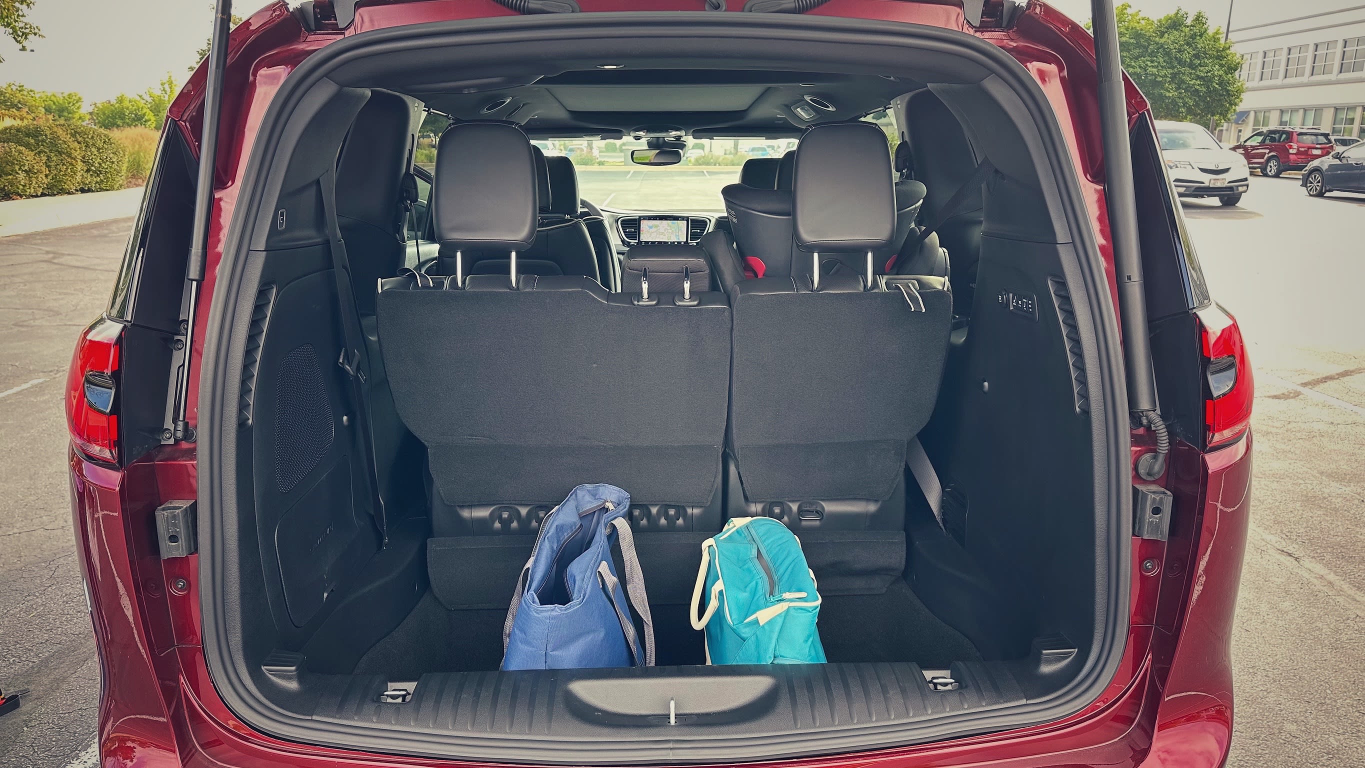 a red 2023 Chrysler Pacifica with the trunk open
