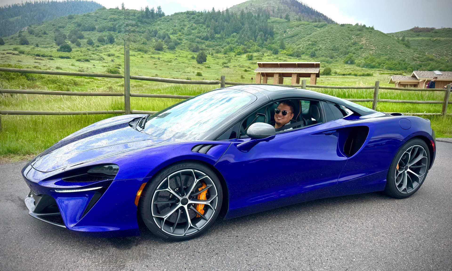 image of a blue McLaren Artura with the author behind the wheel.