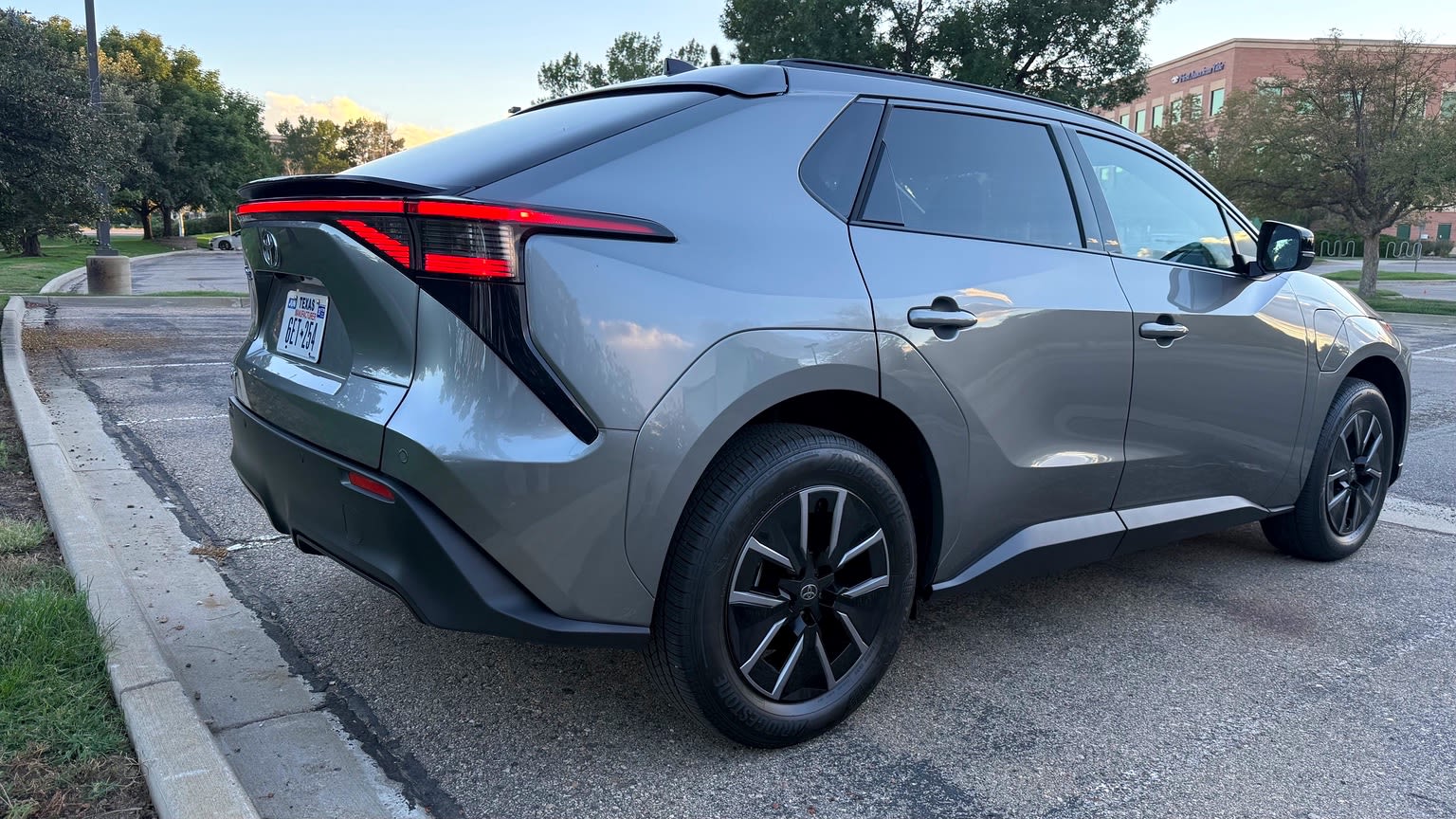 2026 Toyota bZ rear three-quarter view with illuminated red taillights.