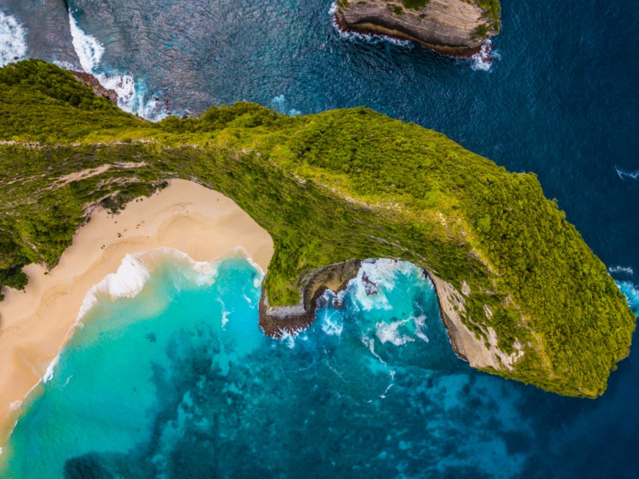 Turquoise water and a green island coastline in Indonesia
