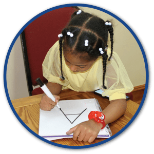 Child practicing writing an uppercase A with systematic instruction