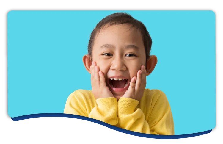 Young child joyfully smiling with their mouth wide open preparing to make a vowel sound