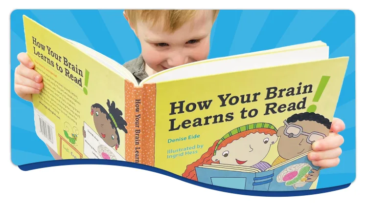 Young child joyfully engaging with the new children's storybook, How Your Brain Learns to Read written by Denise Eide, illustrated by Ingrid Hess