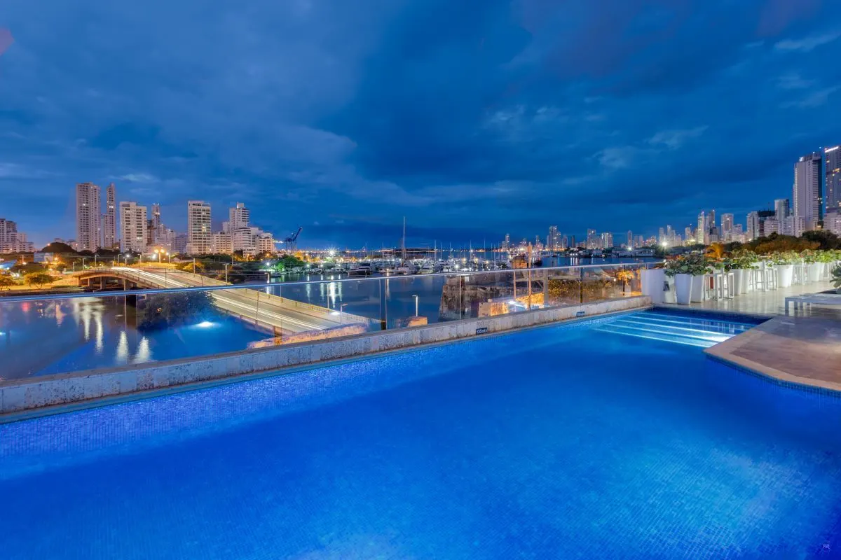 Adultos disfrutando de un cóctel en la piscina de la terraza del Hotel Armeria real