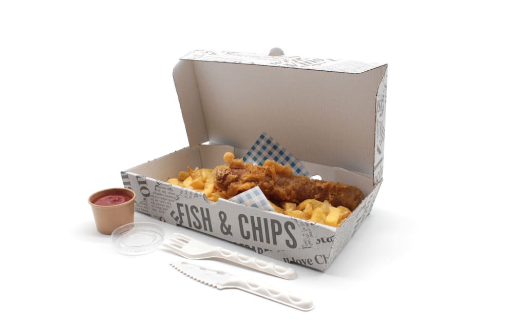 Traditional British fish and chips with hand-battered cod, golden chips, mushy peas, and lemon