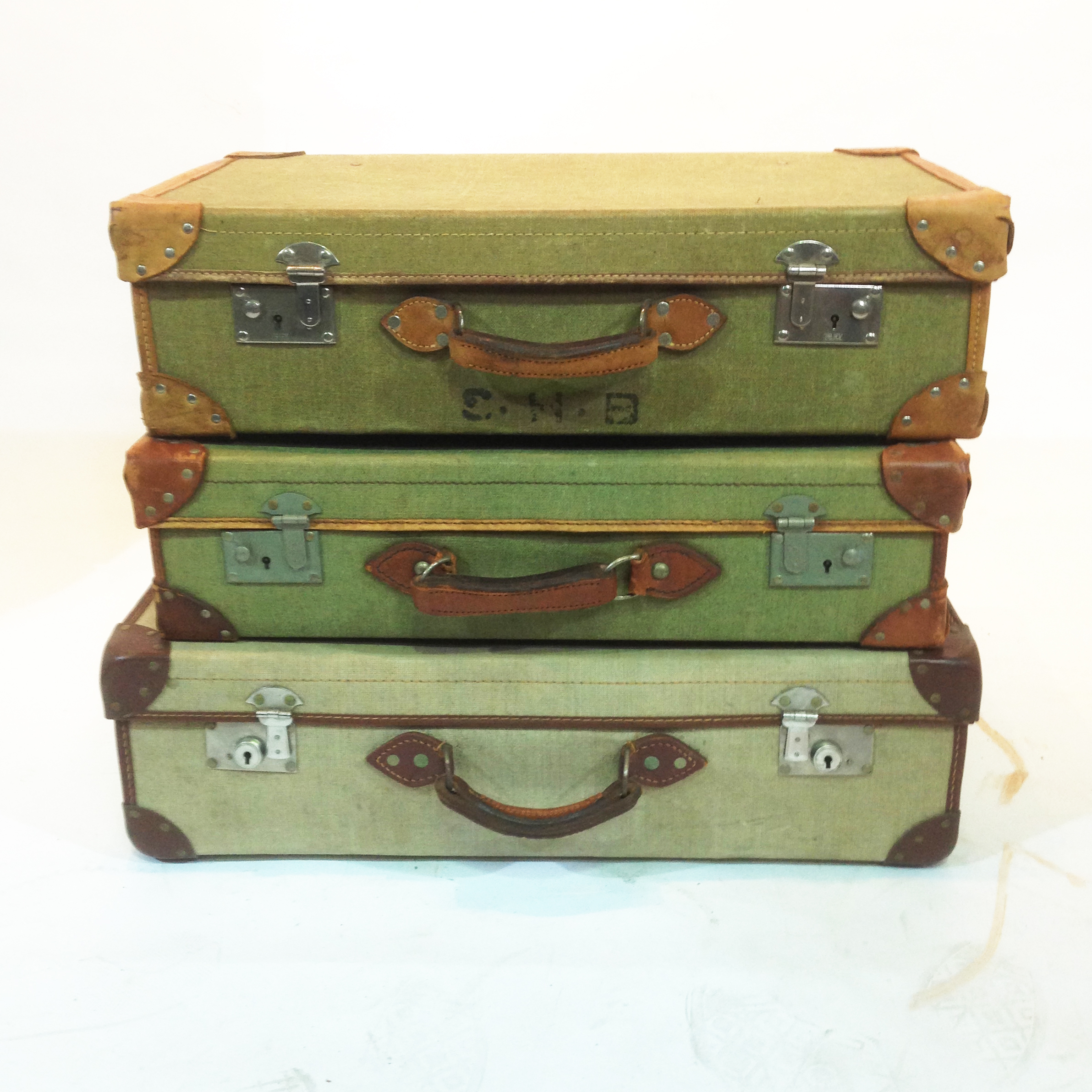Stack Of 3 Green Vintage Canvas Suitcases LONDON PROP HIRE