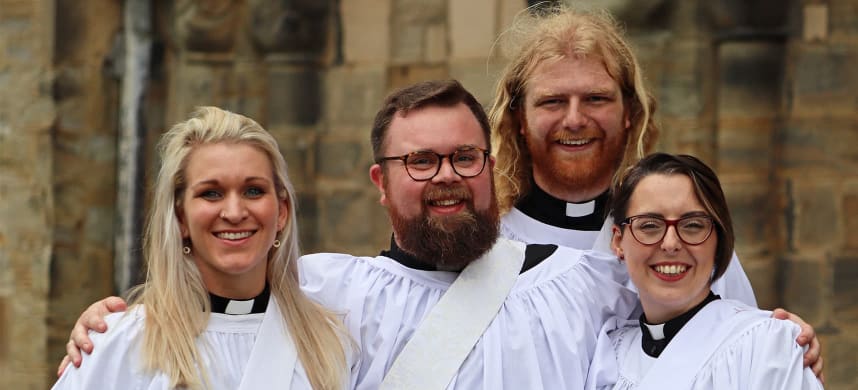 Vicars outside a church