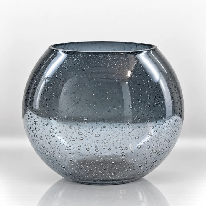 Smoky grey rounded glass candle holder with a bubble-textured surface and wide open top.