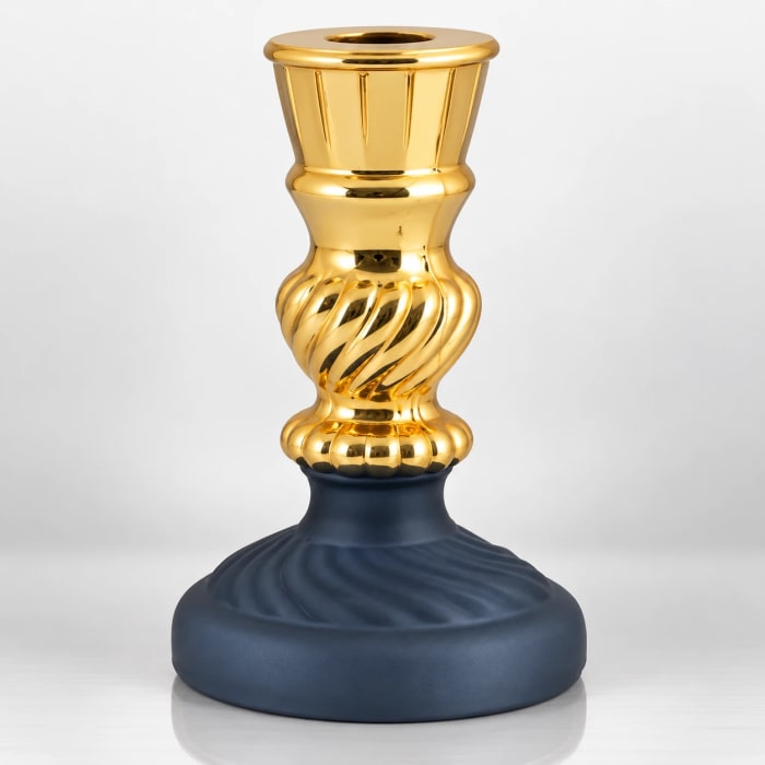 Gold-finished glass candle stand with spiral detailing and dark blue decorative base