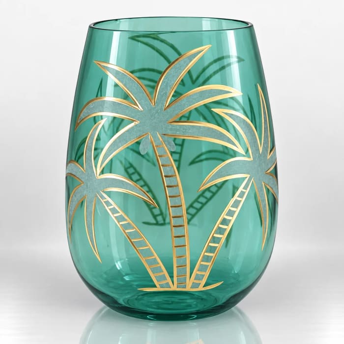 Teal glass candle holder decorated with an elegant gold-accented tropical palm tree design.