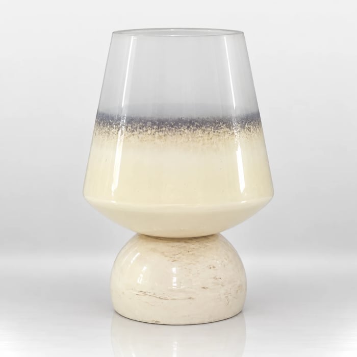Ivory and silver-toned glass candle holder with a rounded pedestal base and tapered upper bowl.