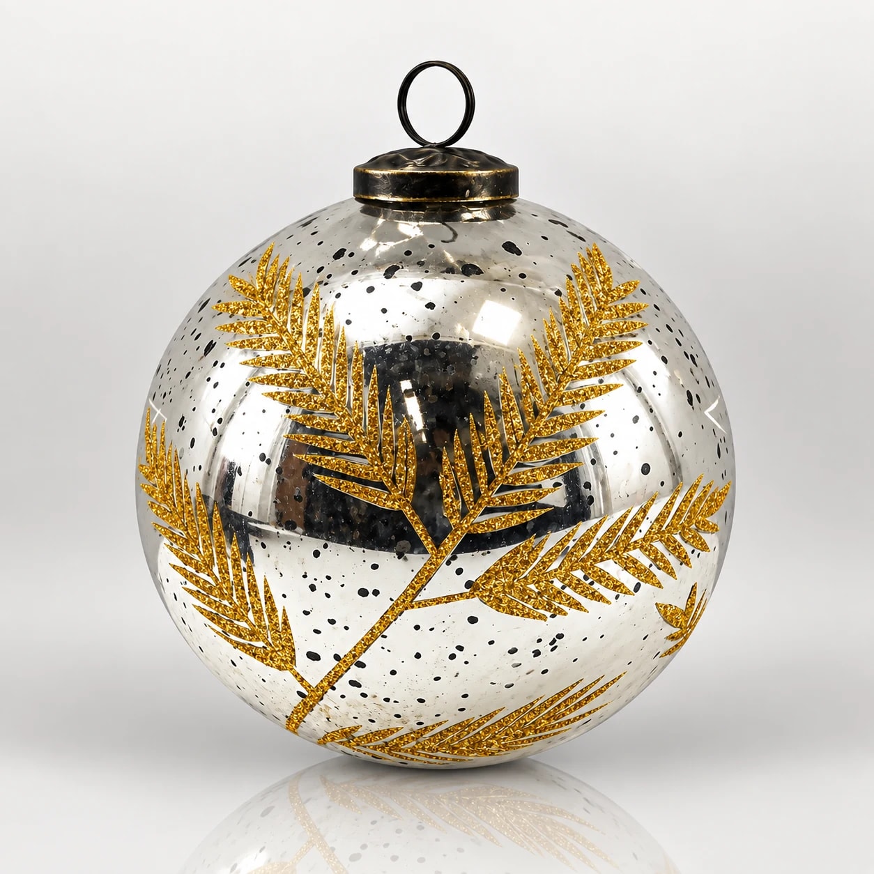 Clear glass Christmas bauble with gold leaf pattern, black speckles, metal cap and hanging loop.