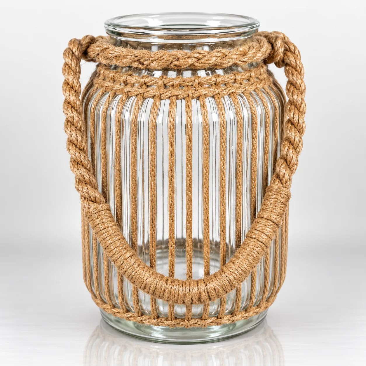 Clear glass candle holder with white woven rope lattice and braided rope handle