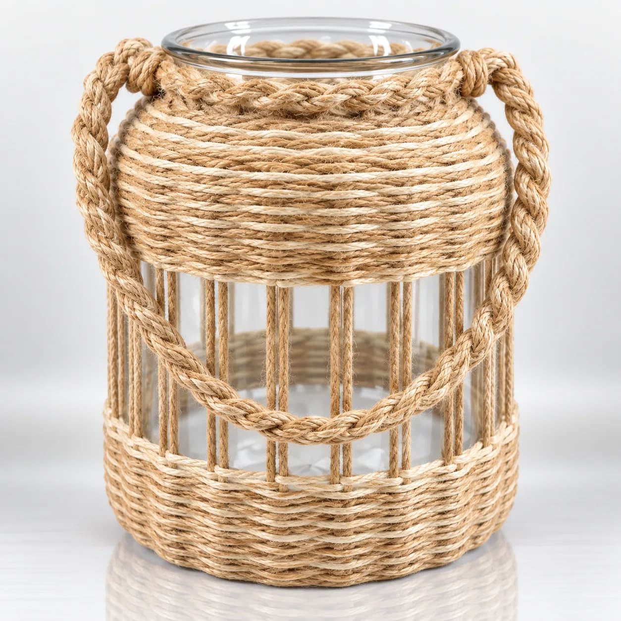 Clear glass candle holder with natural jute rope wrapping, vertical rope detailing and braided rope handle