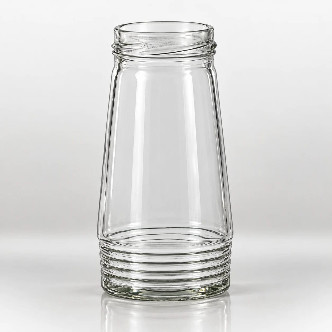 Clear tapered glass jar with raised ribbed detailing around the neck and base