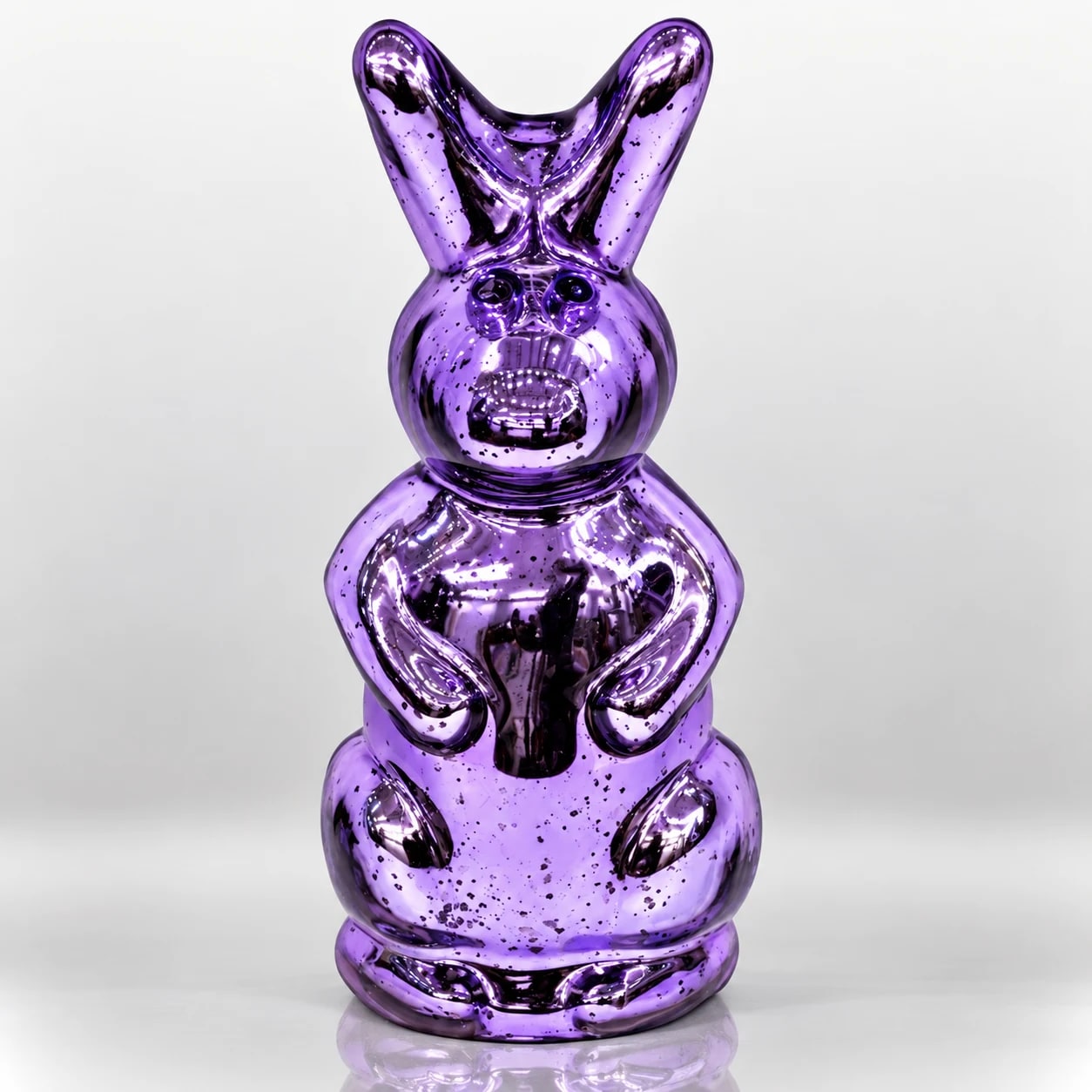 Purple metallic bunny figurine with elongated ears and reflective sculptural finish.