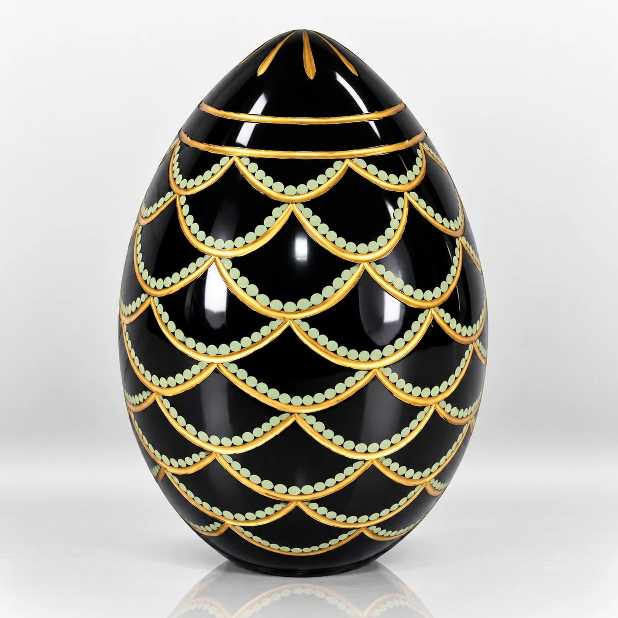 Black Easter egg ornament with gold scalloped detailing and pale green dotted accents.