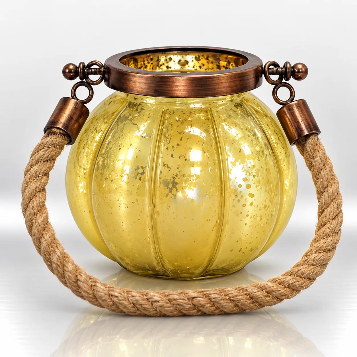 Amber gold ribbed glass candle holder with distressed metallic detailing, copper-tone collar and braided jute rope handle.