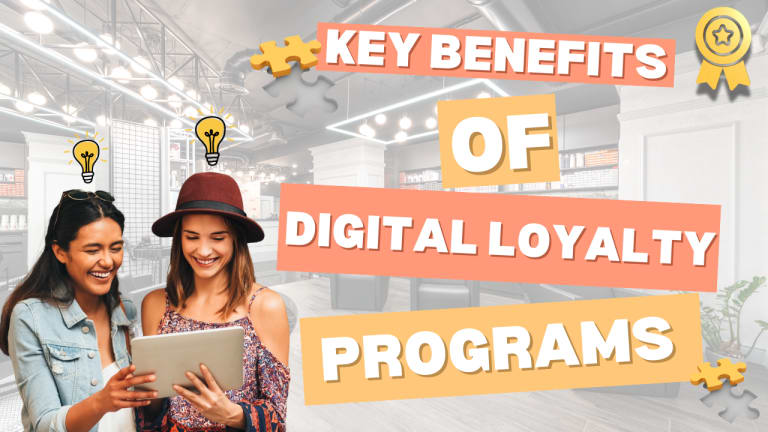 Two smiling women look at a tablet with text saying, "Key Benefits of Digital Loyalty Programs" in the background.
