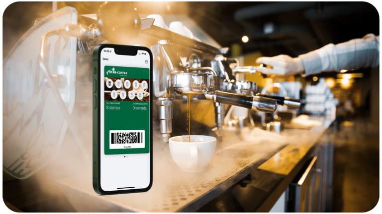 A phone with a qr code on it in front of a coffee shop.
