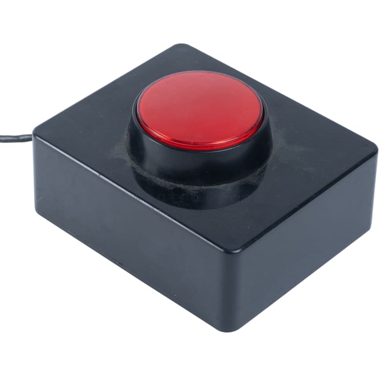 Large round red button mounted in black plastic box